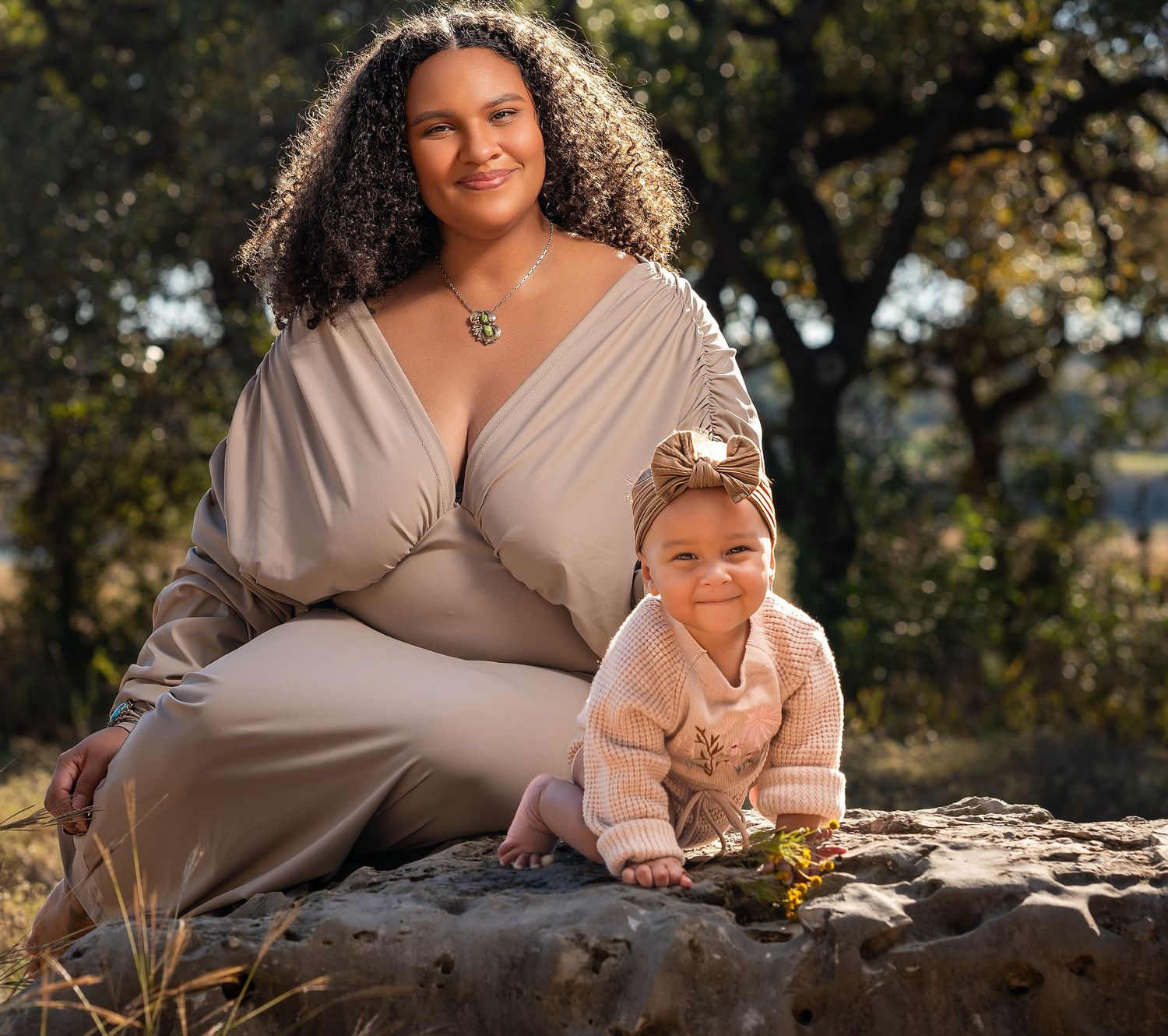 Mother and baby portraits in natural lighting with golden sunlit backdrop.