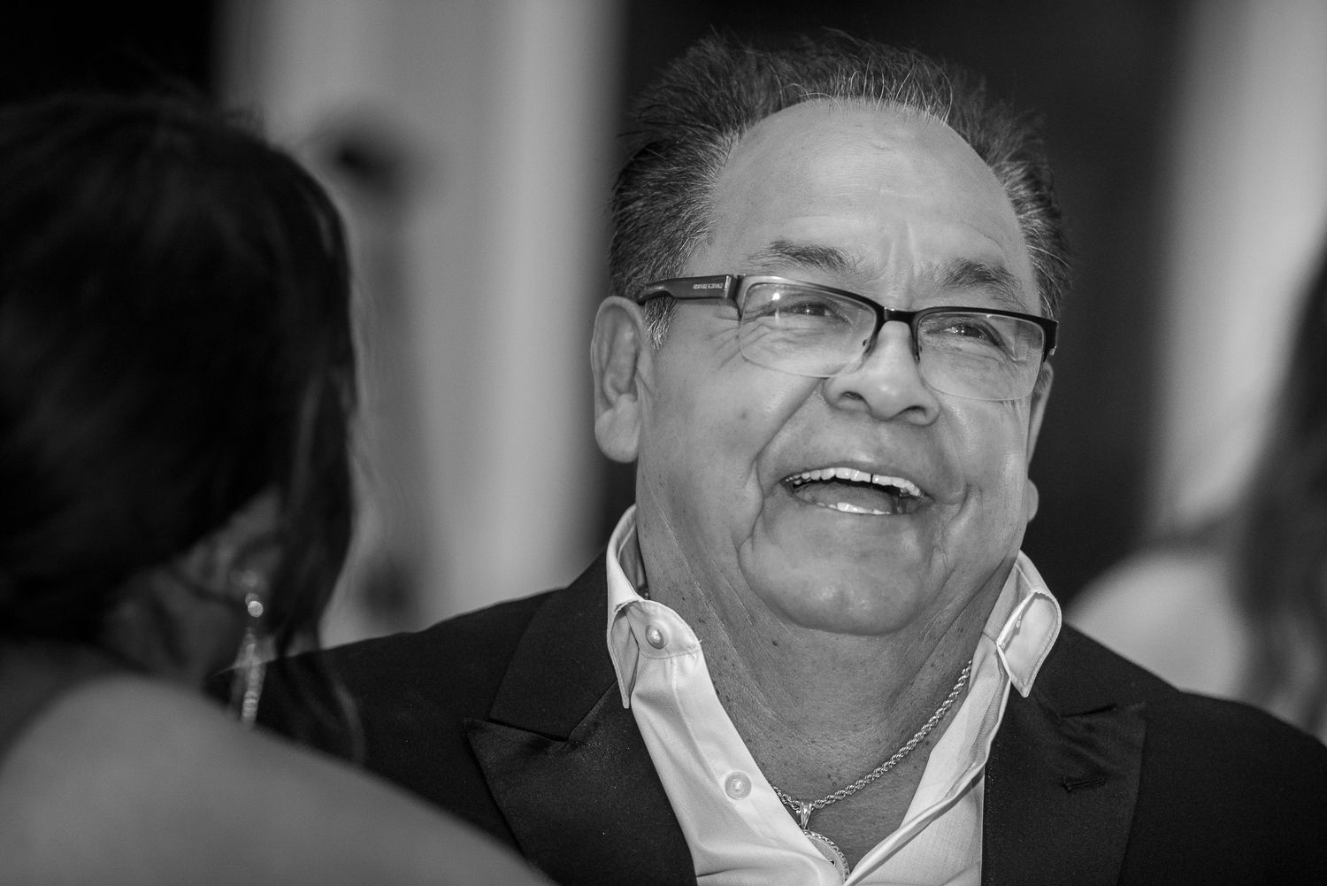 Black and white photo of guests enjoying themselves at a formal celebration.