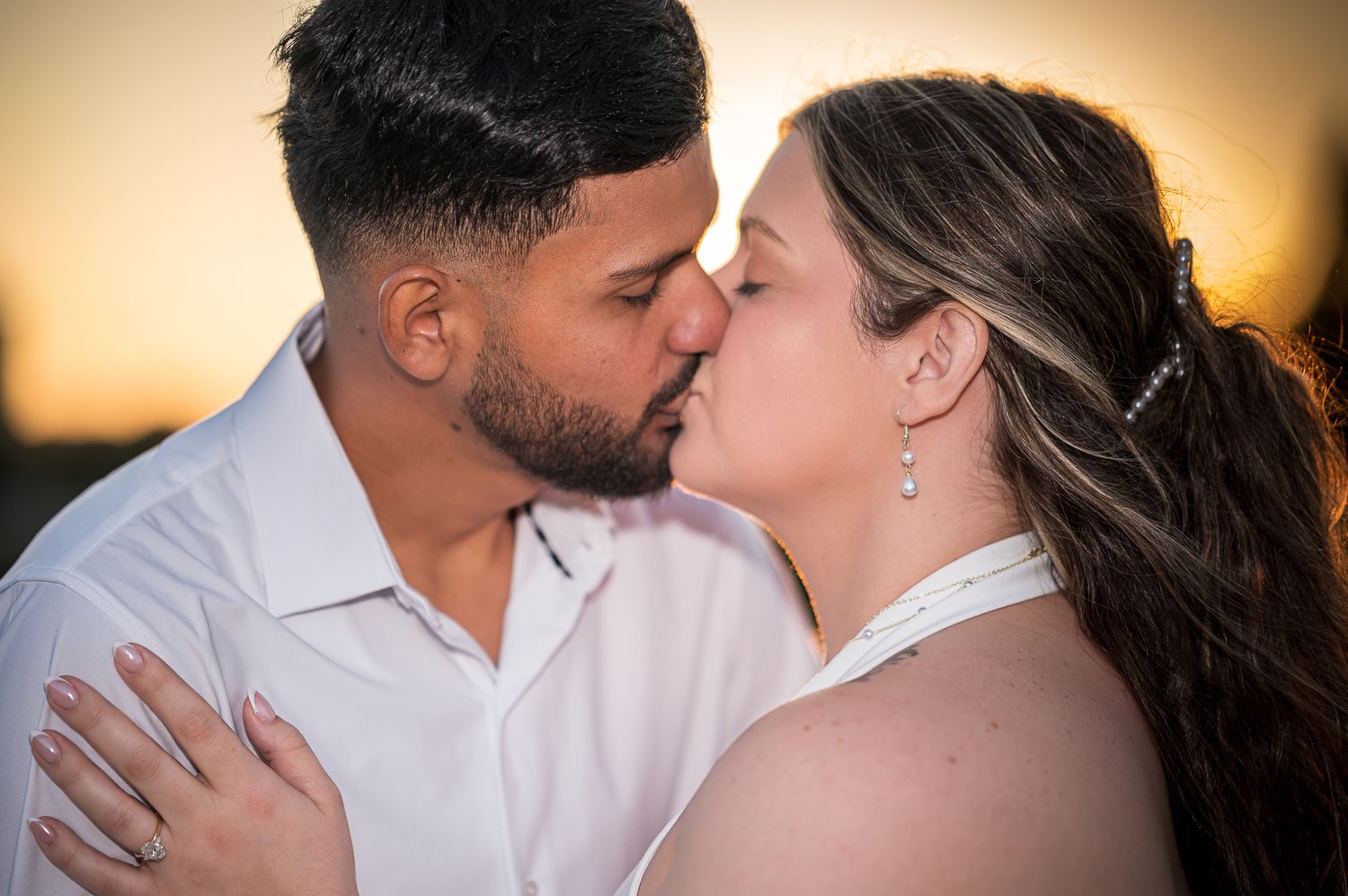 A tender romantic moment captured between a couple during sunset.