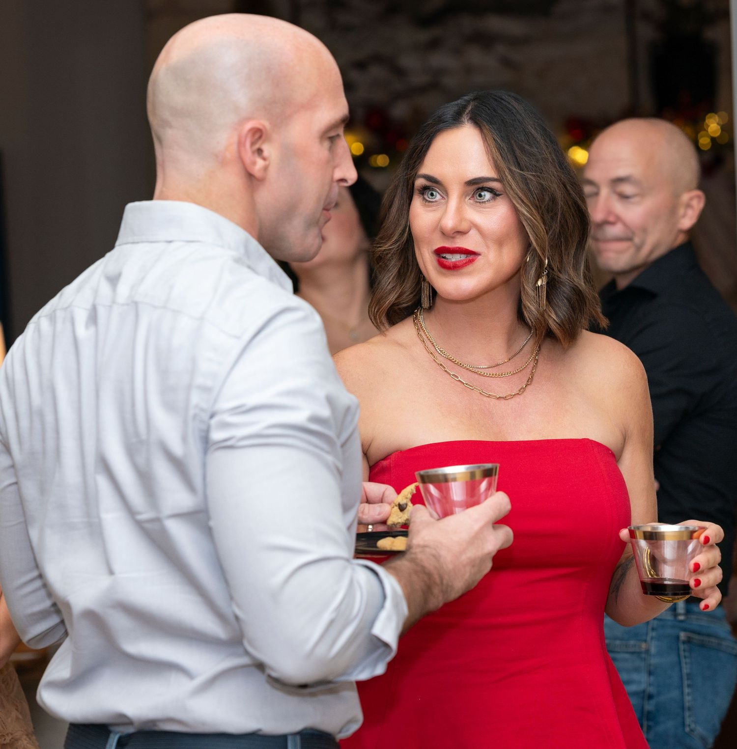 People socializing at an elegant evening event with formal attire.