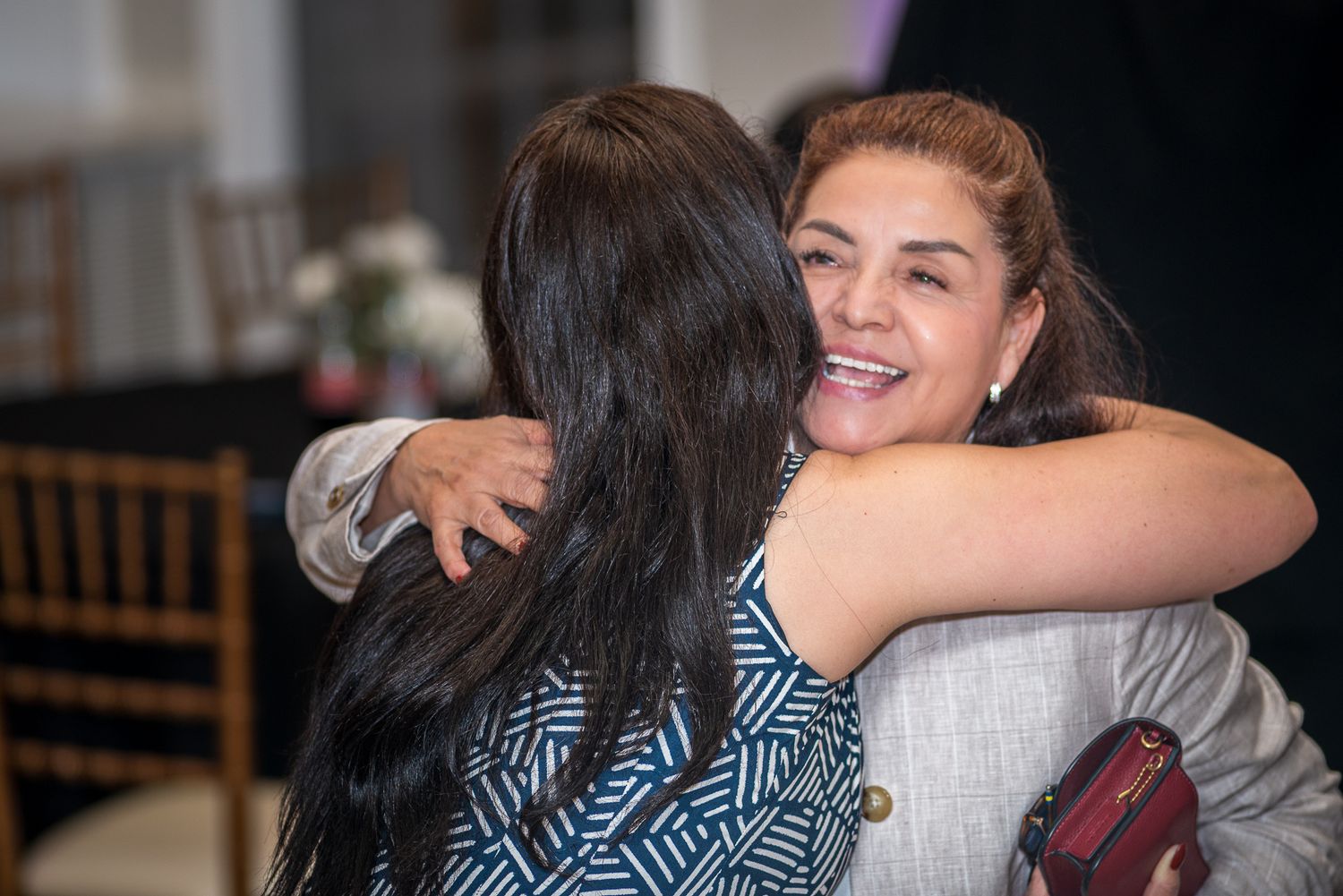 Emotional embraces and hugs shared between attendees at a formal event.