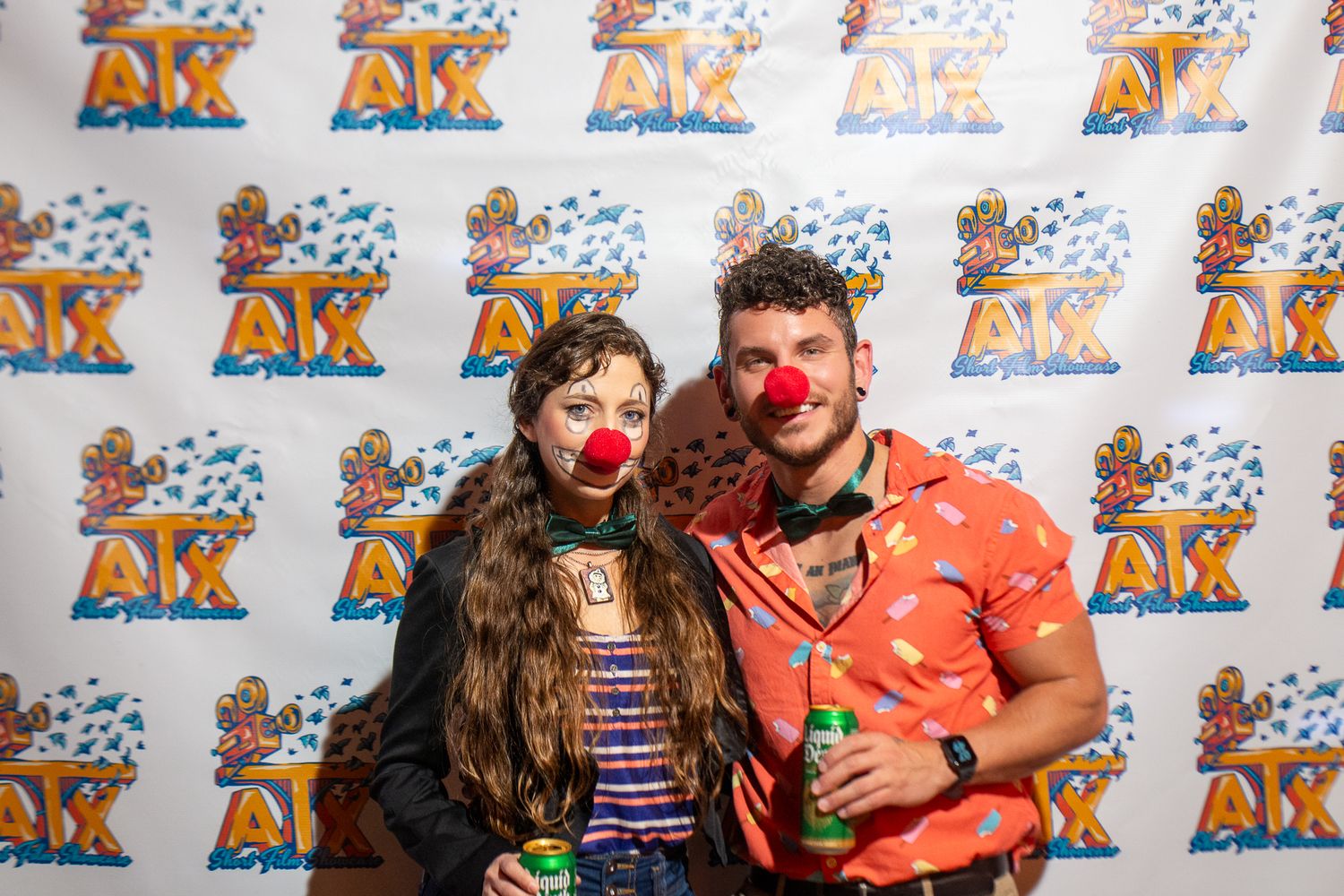 Group photos taken at an event with a branded backdrop featuring cartoon characters.