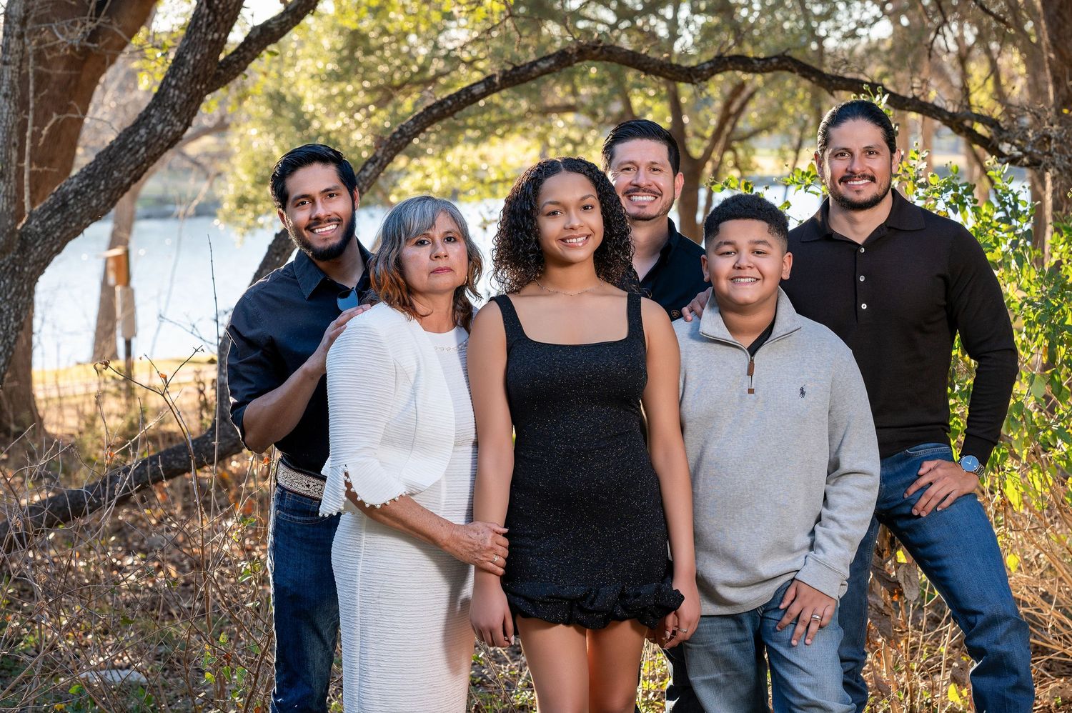Group photo of family members arranged in casual poses outdoors.