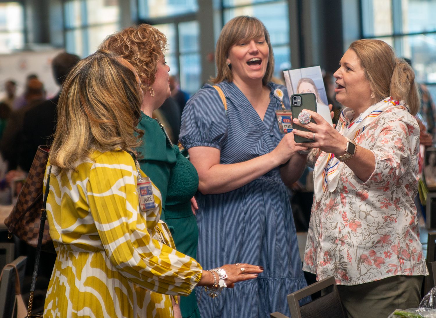 People networking and socializing at a corporate event in business attire.