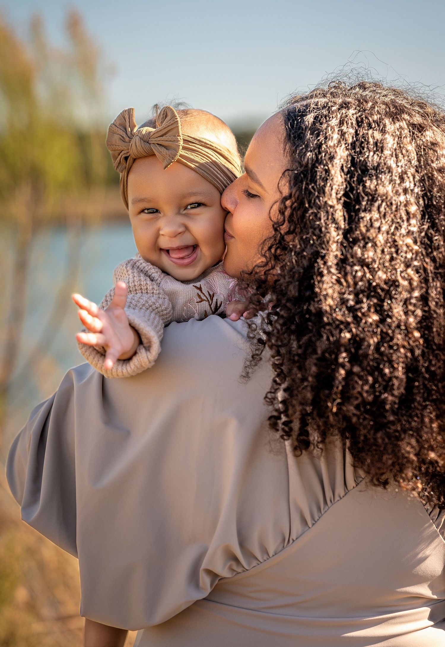 A tender moment captured in a series of five photos showing affectionate embraces outdoors in warm sunlight.