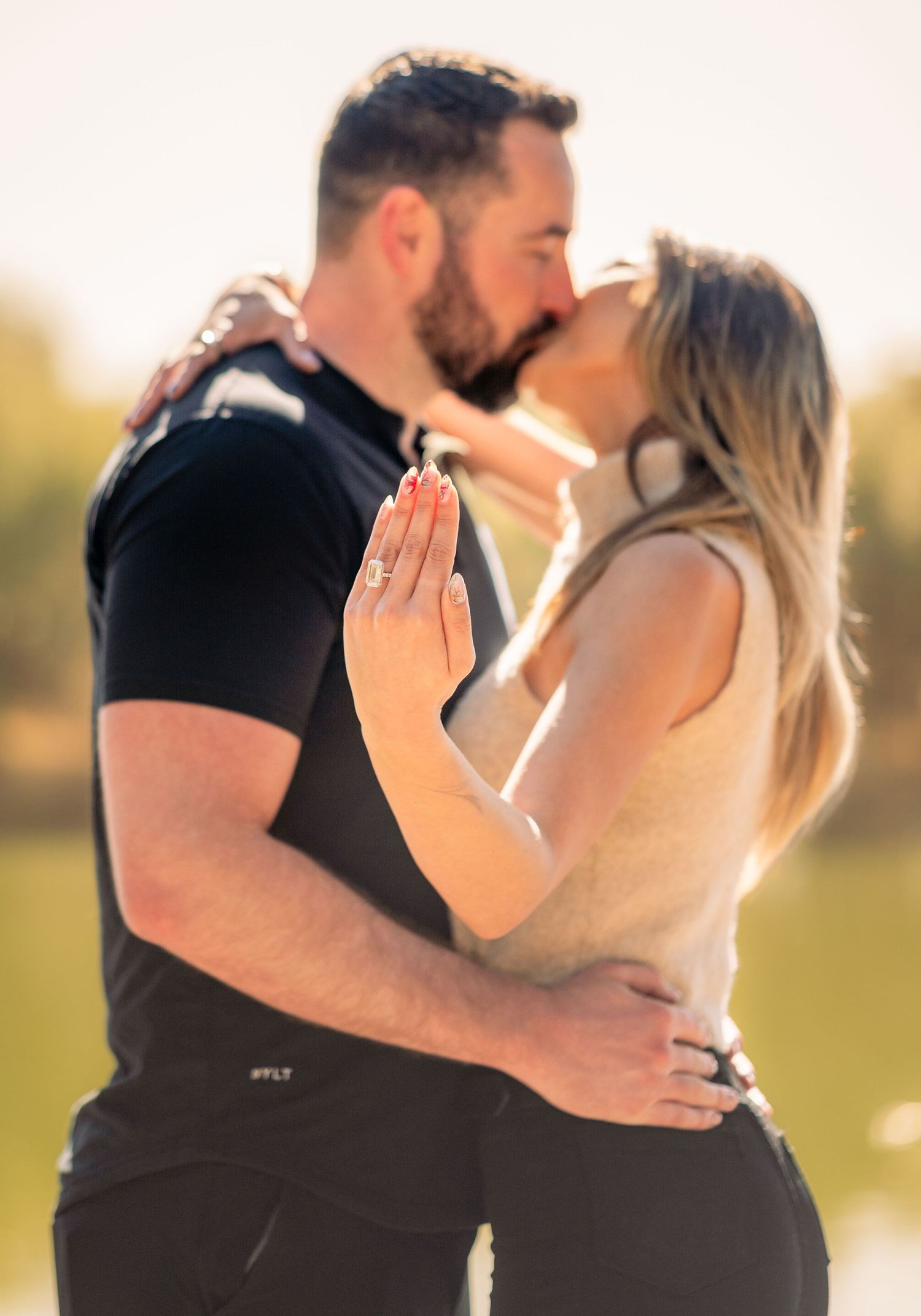 A sunset engagement sequence showing an emotional proposal in a park setting.