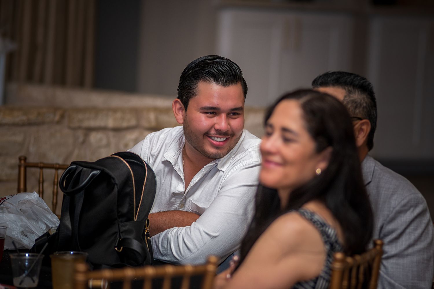 Candid moments of laughter and conversation at a social gathering.