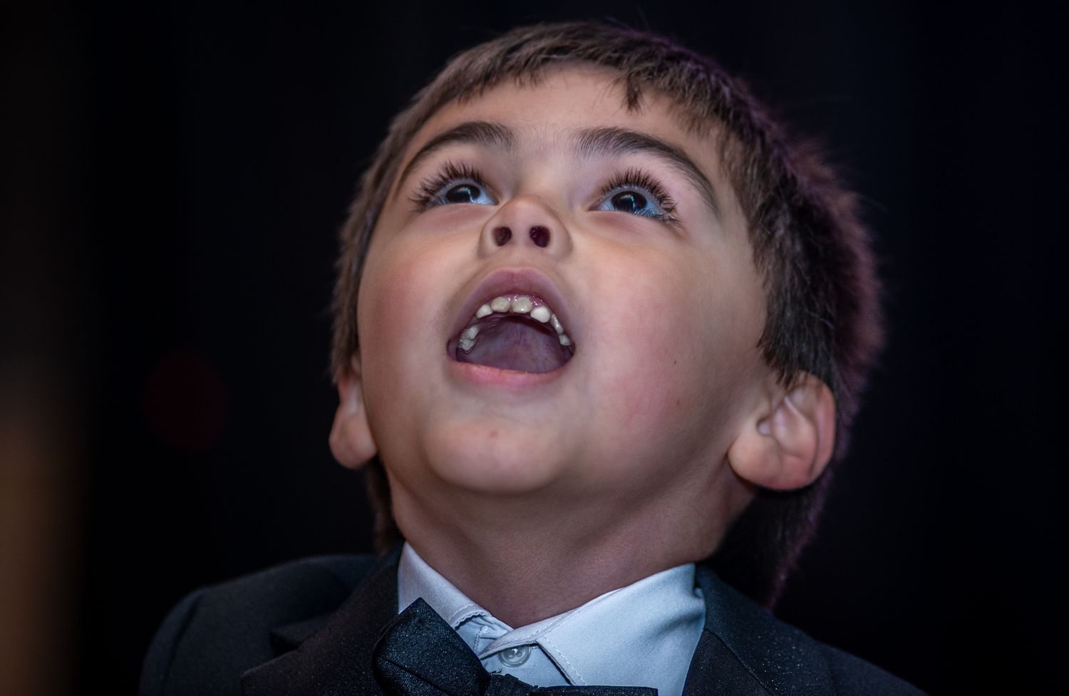 A series of candid expressions and reactions captured in black and white at a social event.