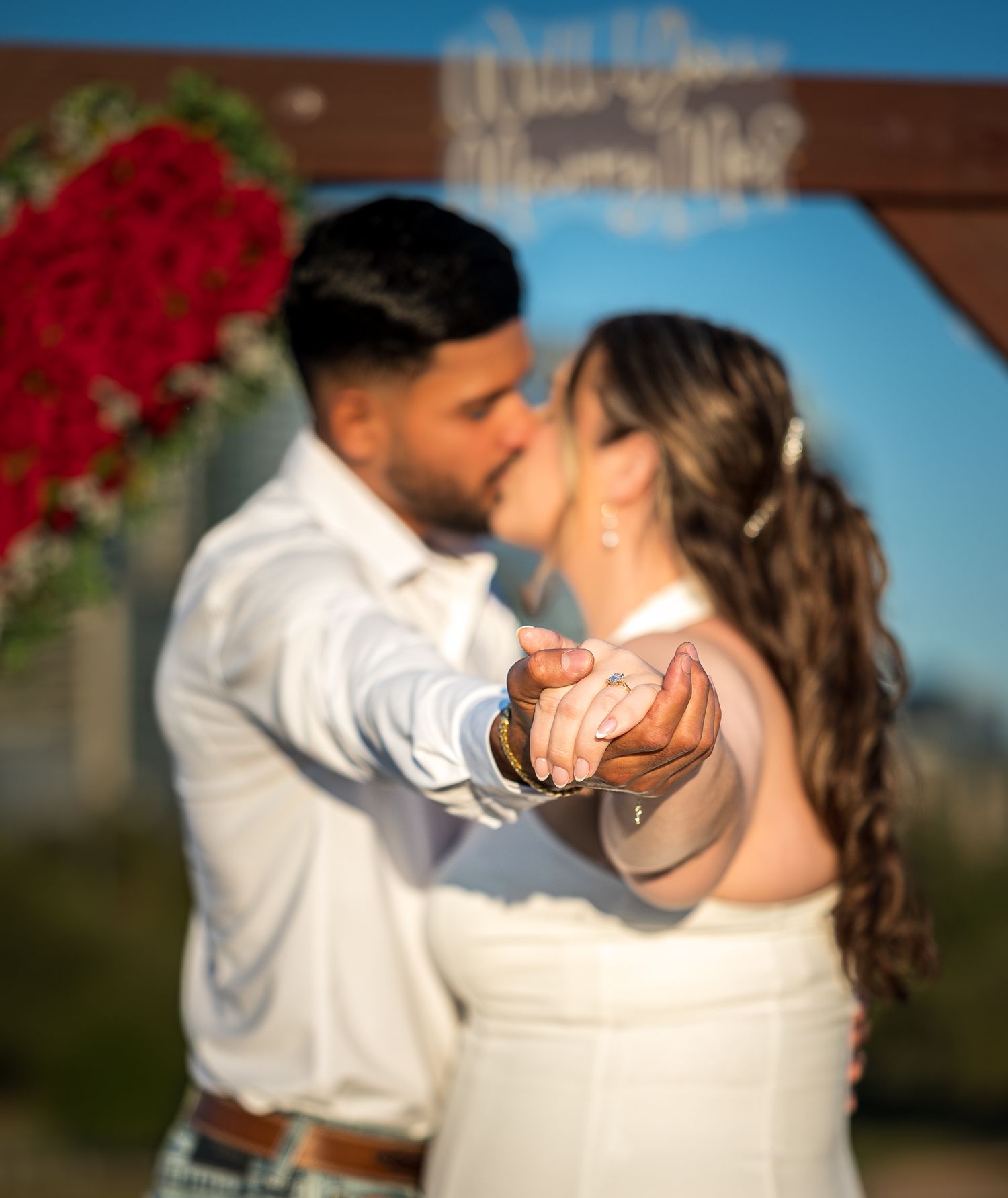 A sunset proposal sequence with red flowers and city skyline in the background.