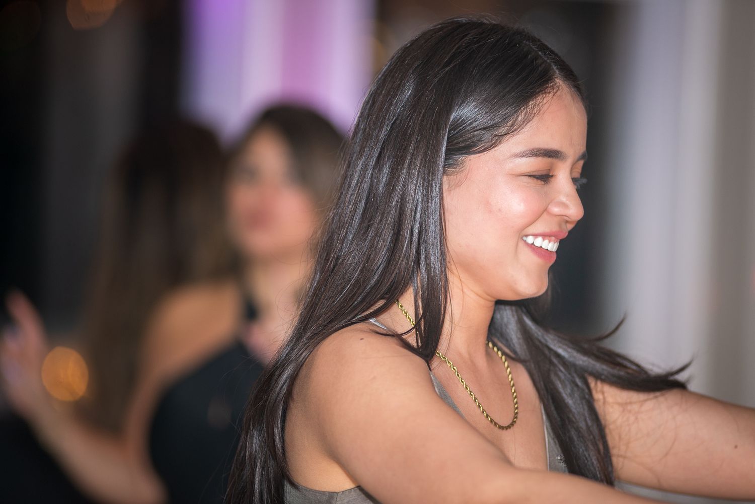 Candid moments of laughter and joy captured during an evening celebration.