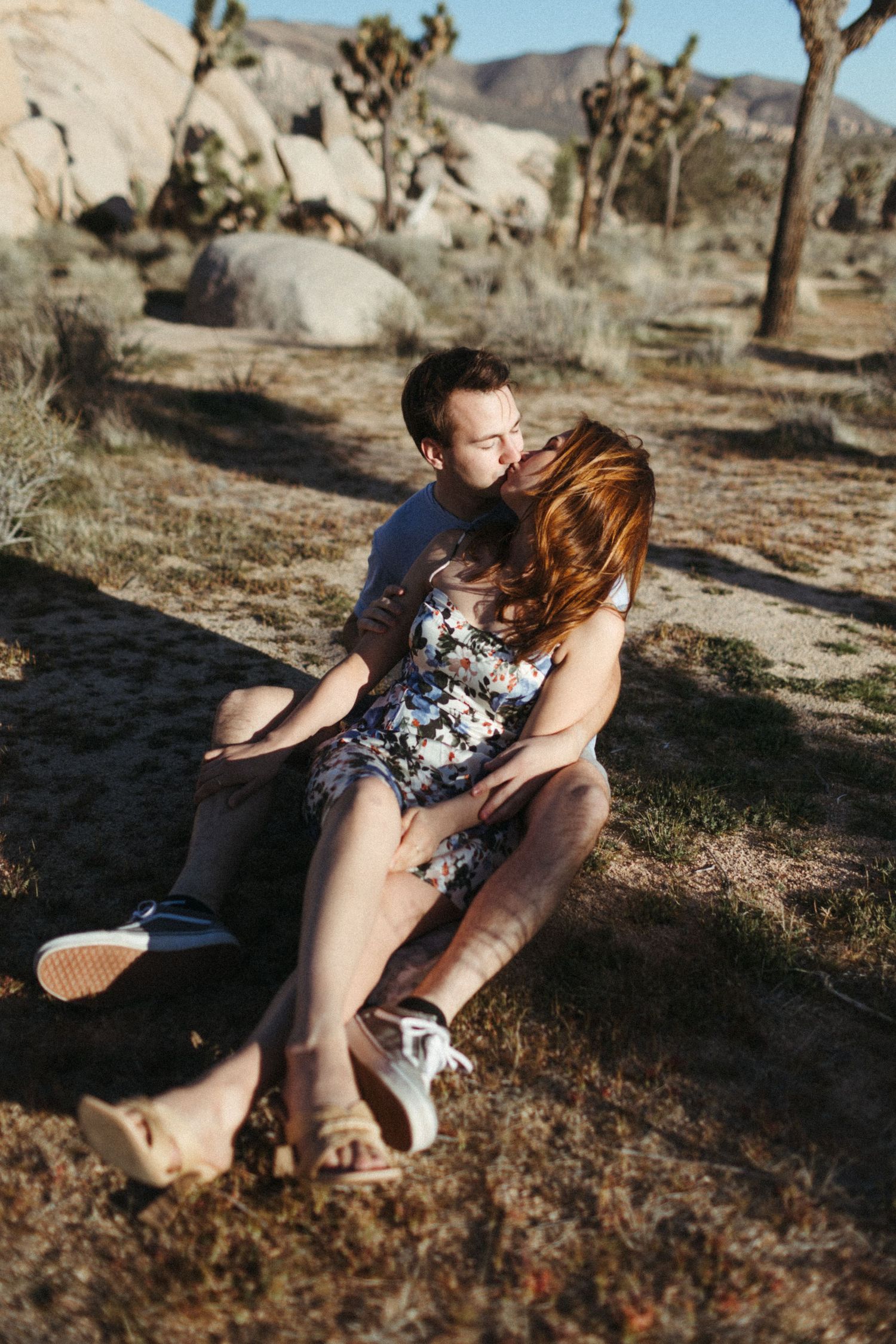 couple kisses at joshua tree national park during engagement photos