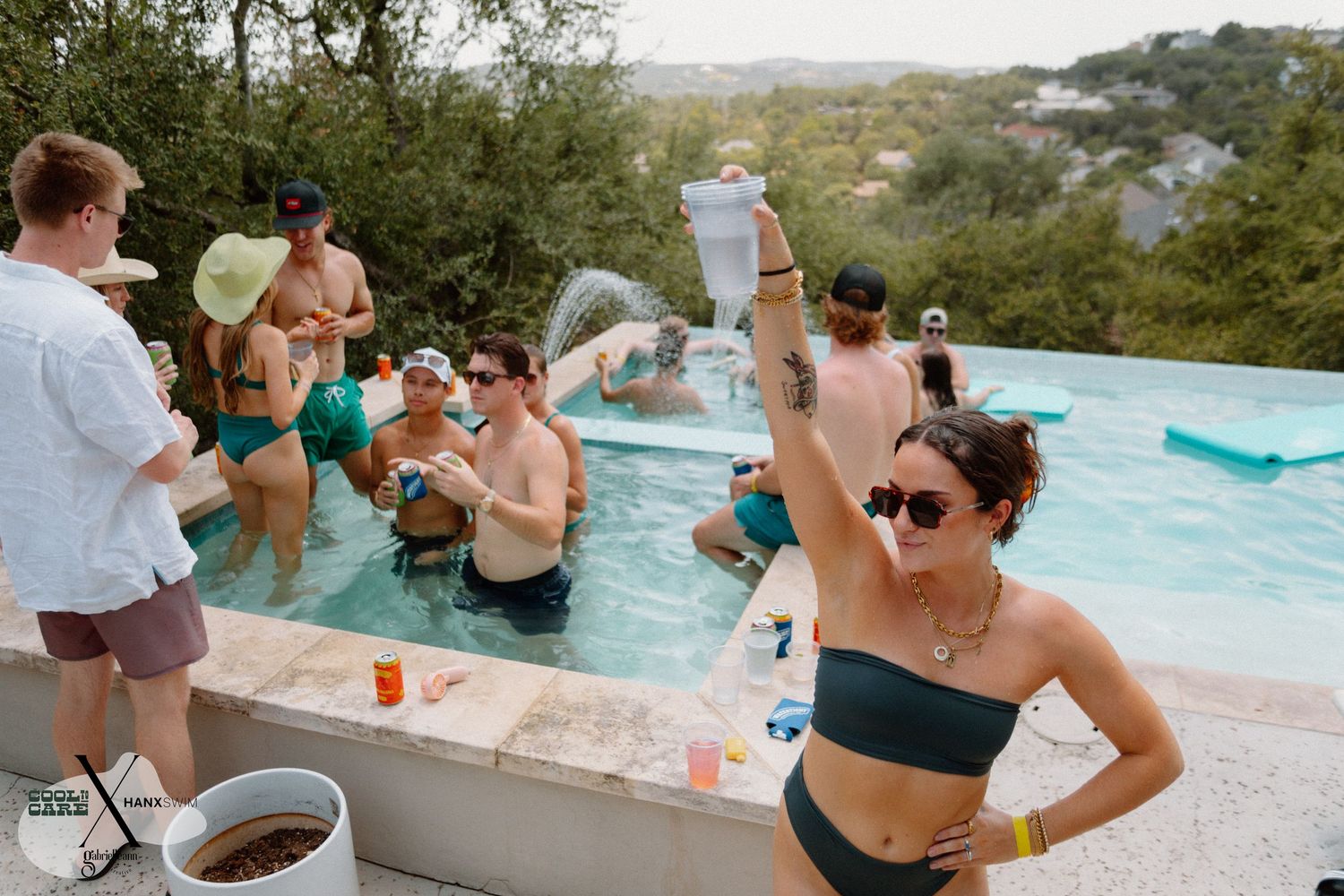 Group of people relaxing and socializing at an outdoor pool gathering.
