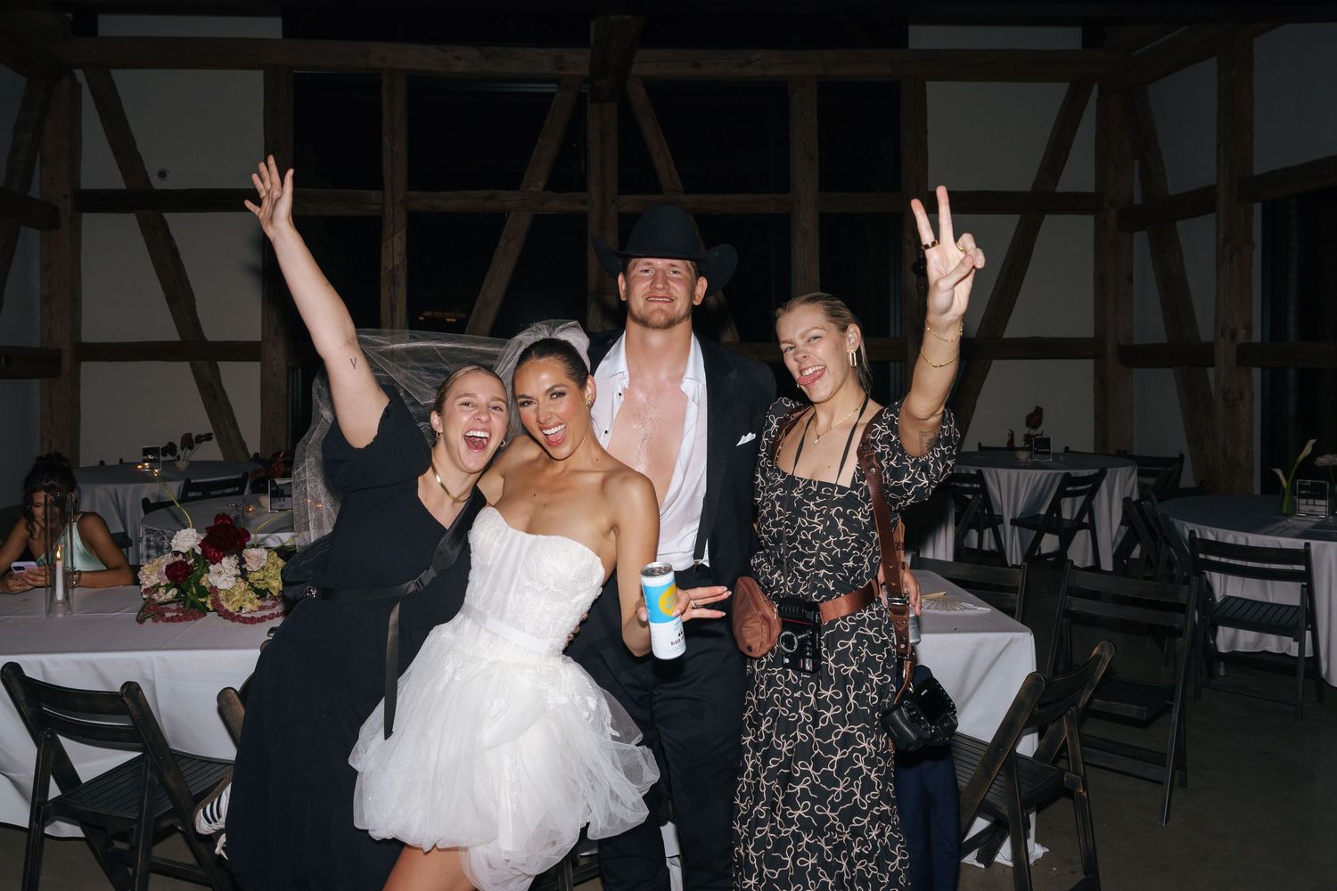 People celebrating and posing for photos at an evening party.