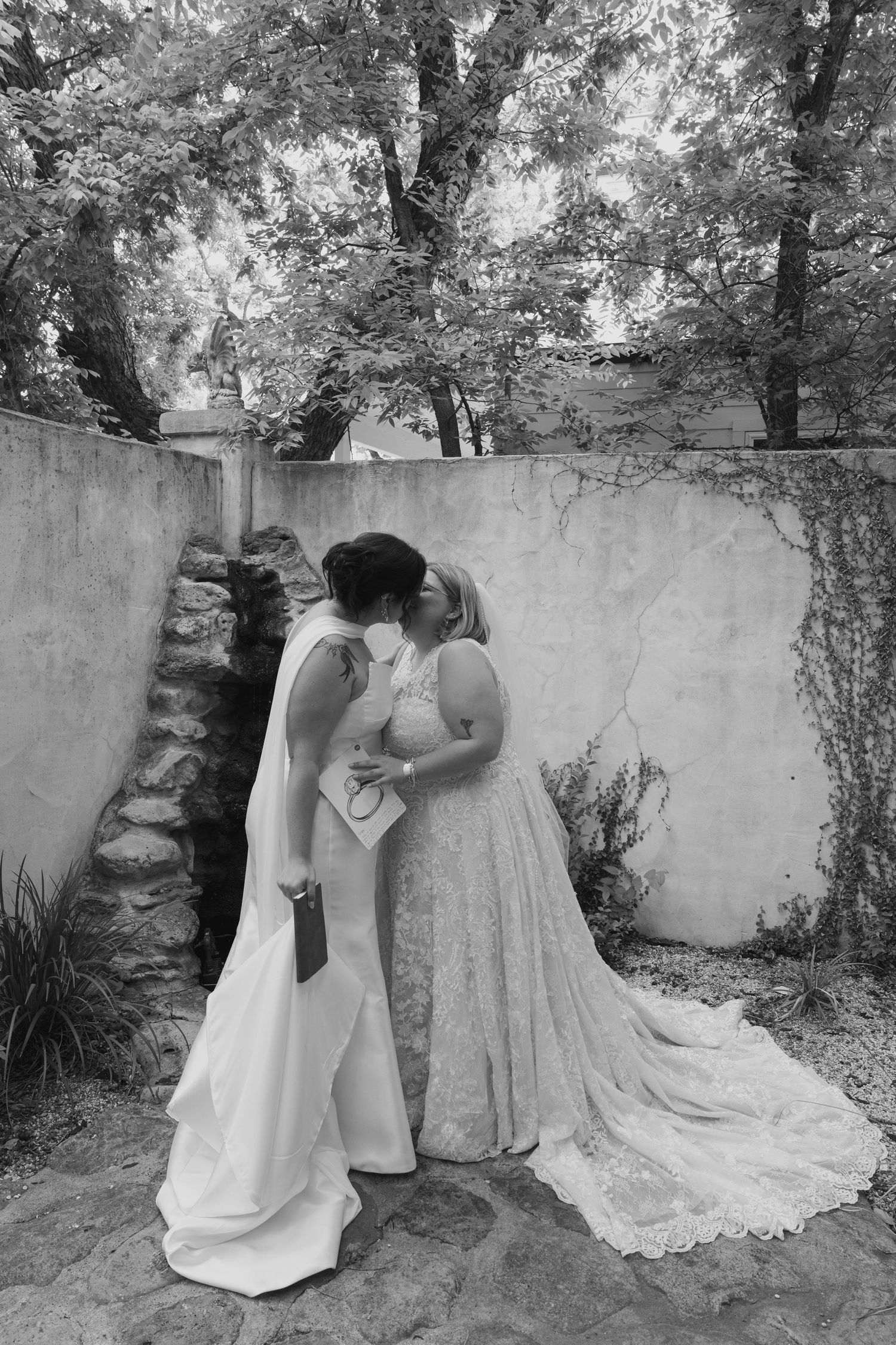 A sequence of black and white wedding photos showing tender moments between a couple in a garden setting.