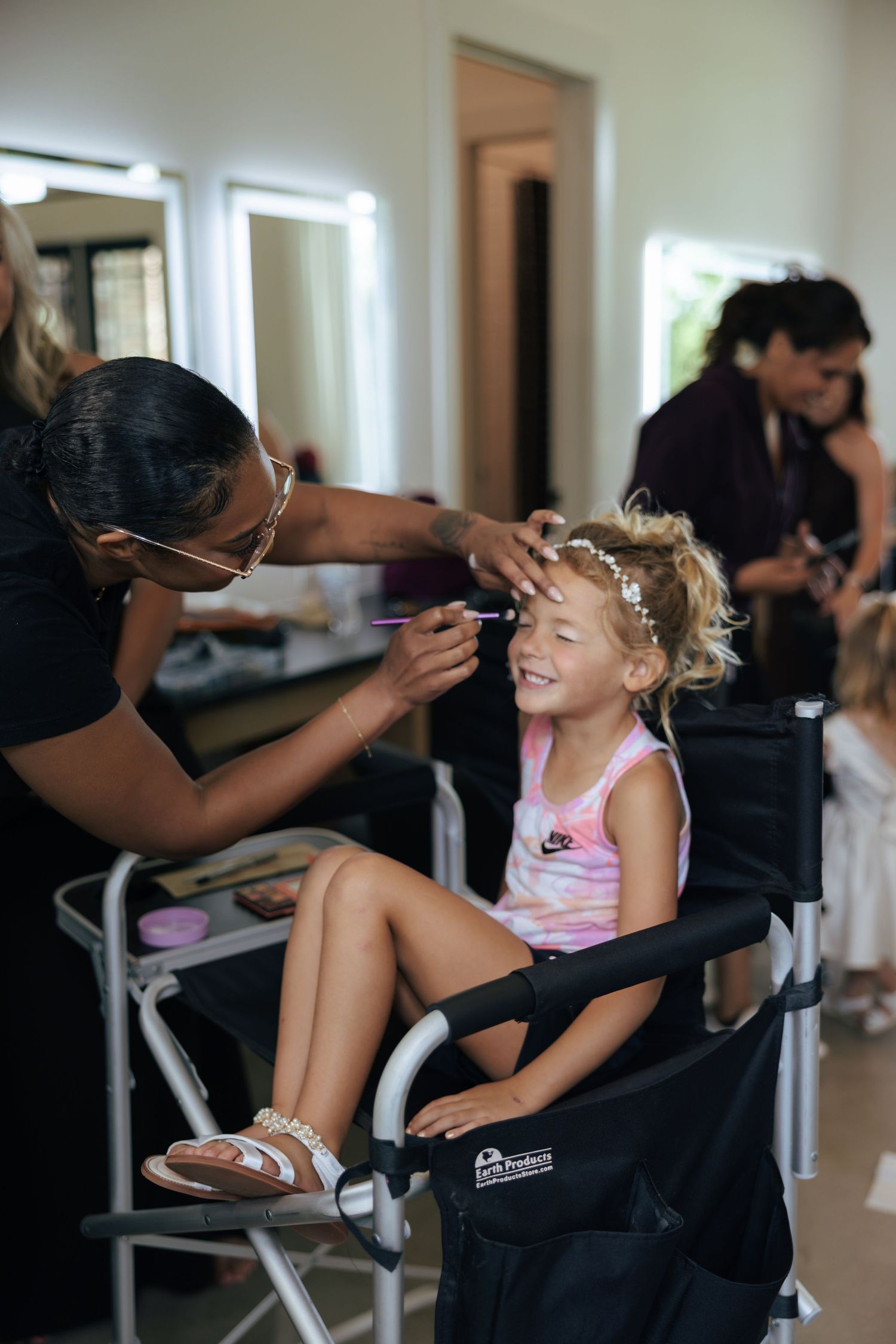 Wedding day makeup preparations in a bright, modern salon setting.