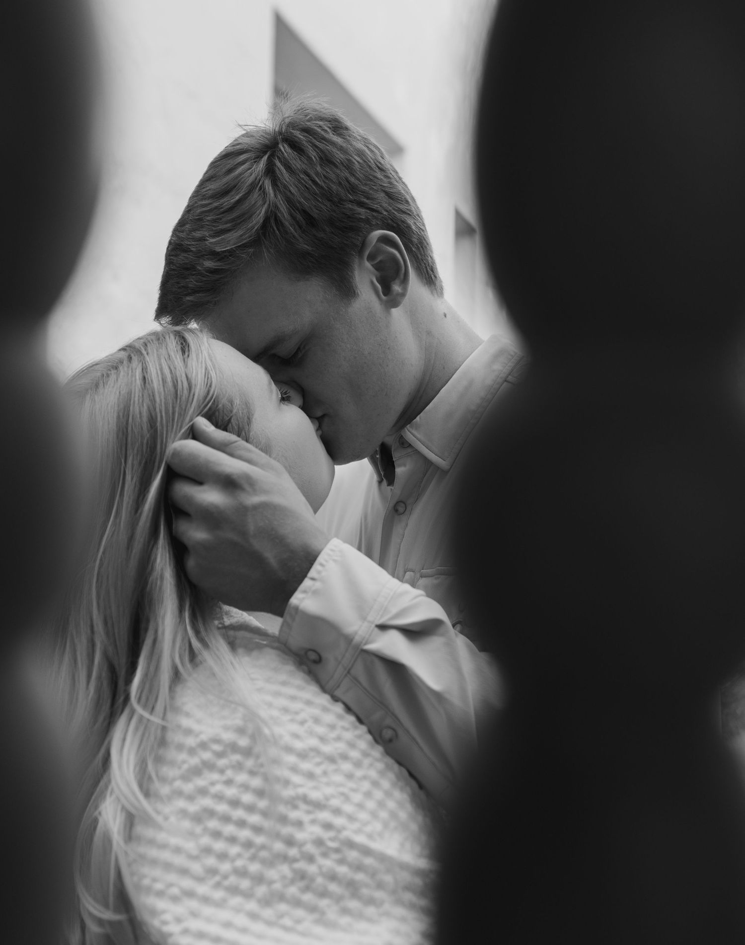 Black and white romantic photo sequence showing tender embrace and intimate moments between a couple.