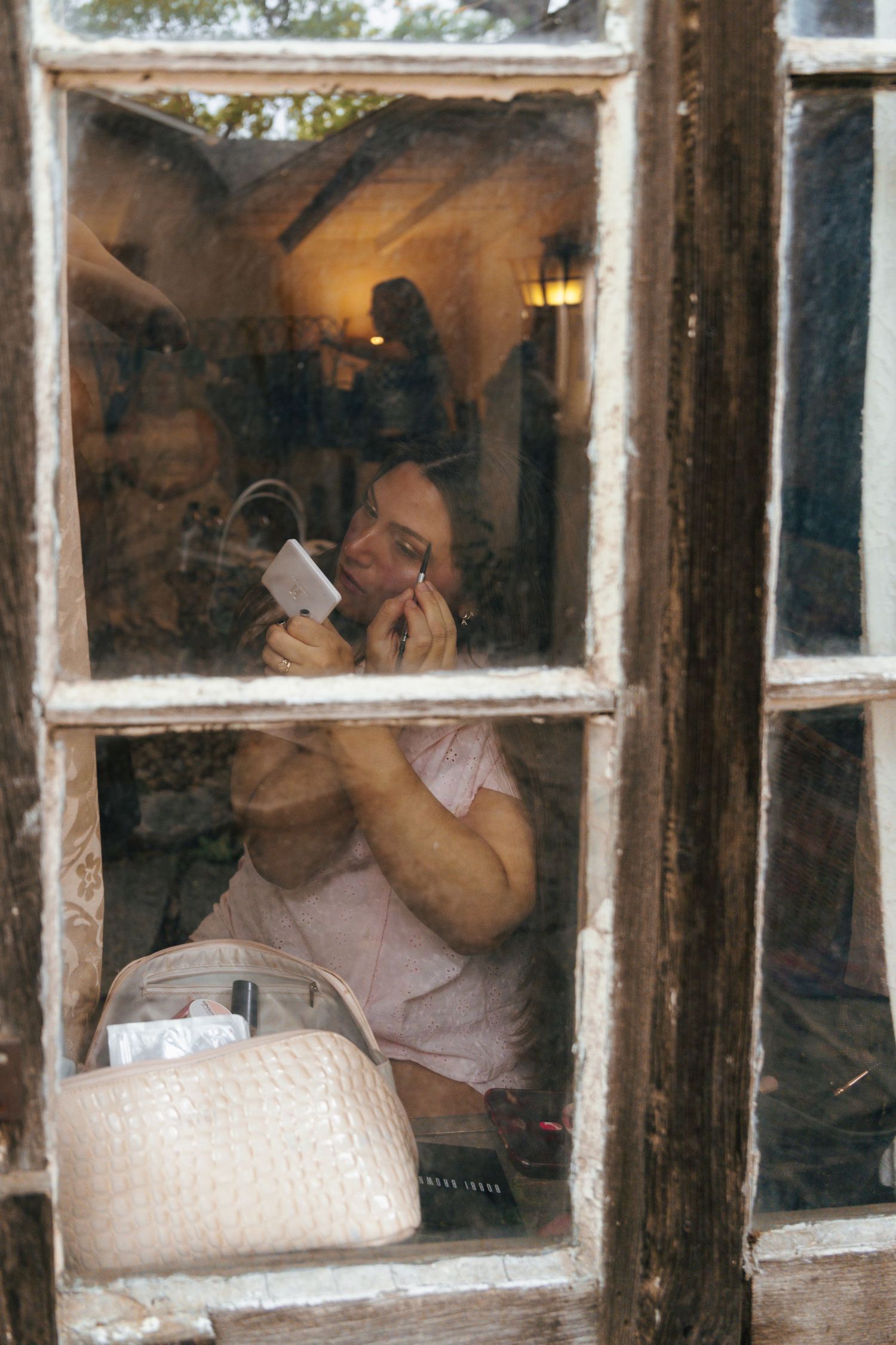 Three panes of a window show a person drinking from a glass in different poses, creating a sequential motion effect.