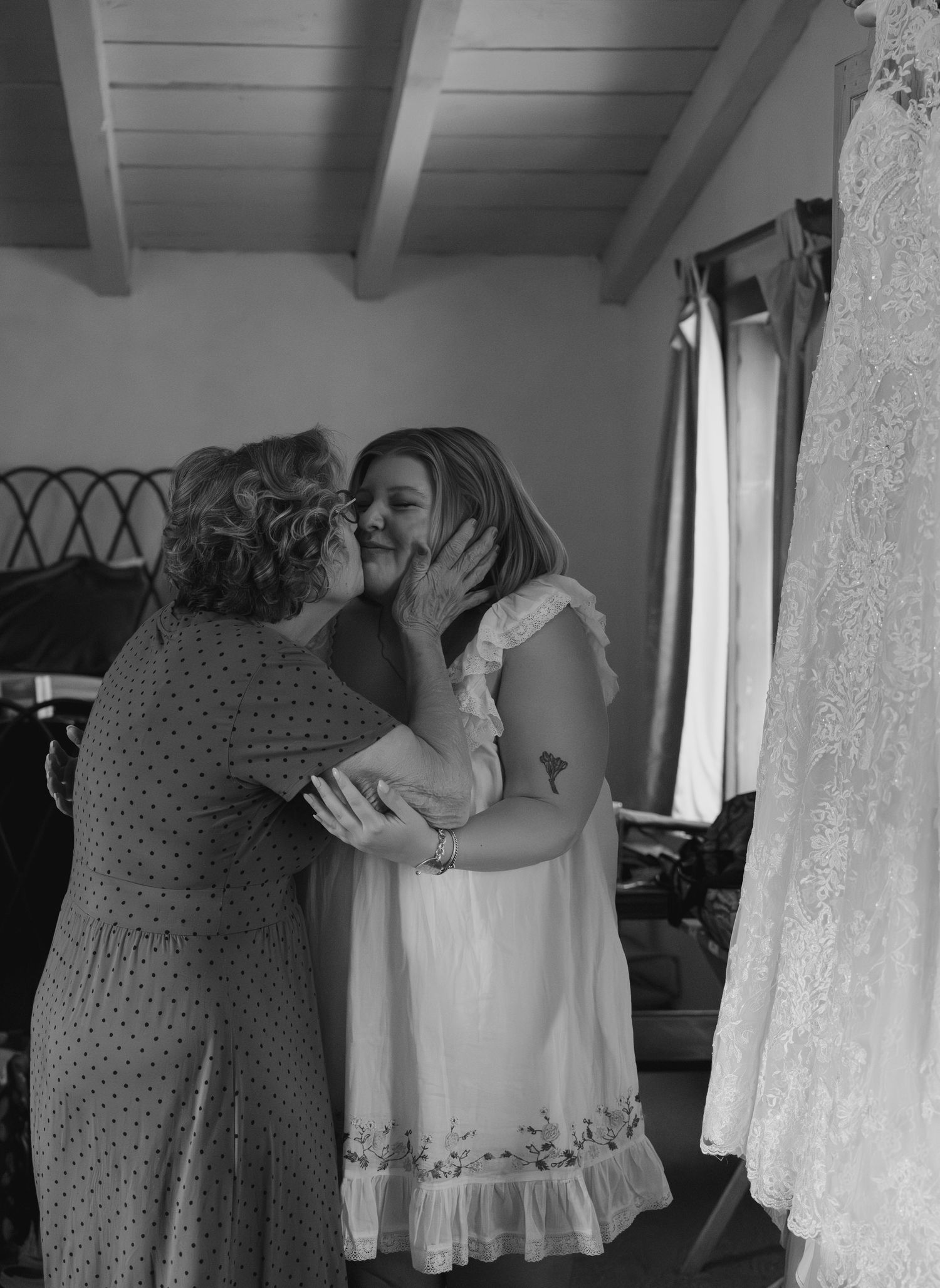 Black and white photo series showing emotional moments during wedding dress preparations in a bridal suite.