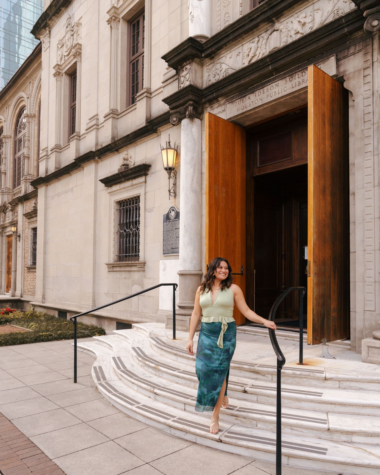 Architectural view of historic building entrance with stone steps and columns.