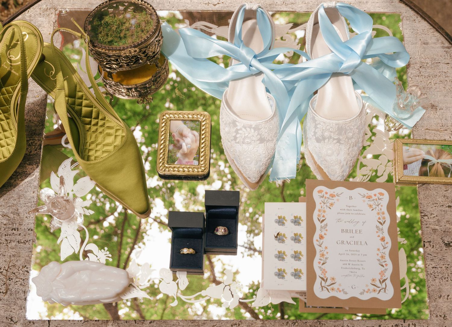 A romantic wedding reception table setting with white floral centerpieces, greenery, and elegant calligraphy menus.