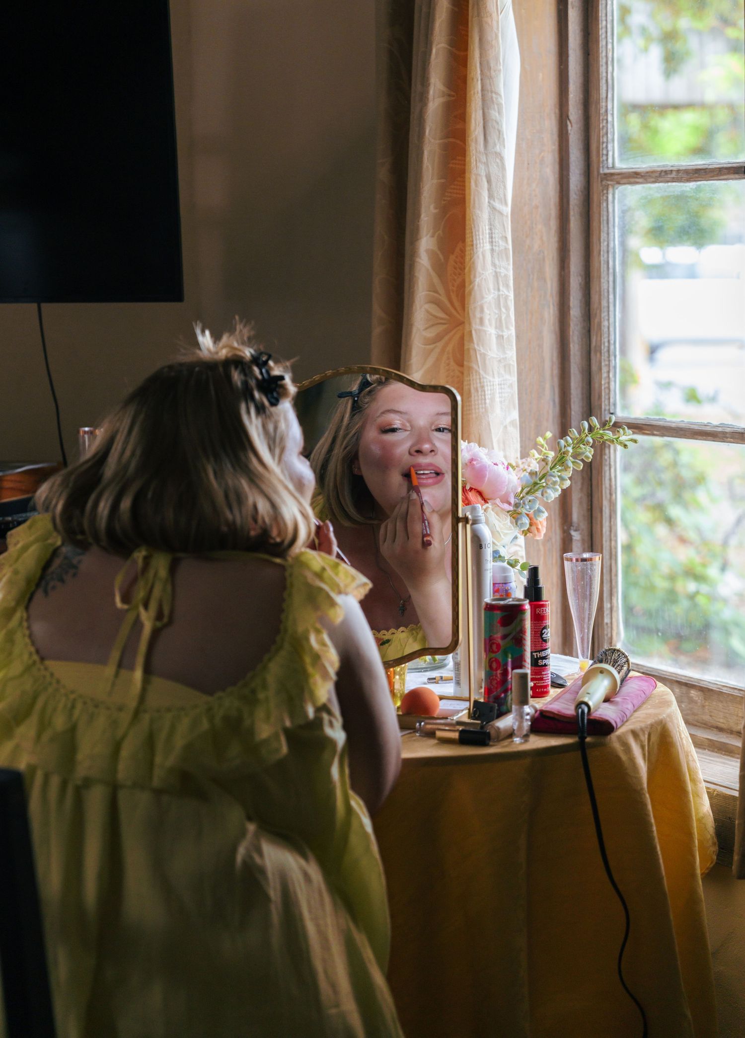 A sequence of photos showing someone in a yellow top sitting by a window drinking from a glass.