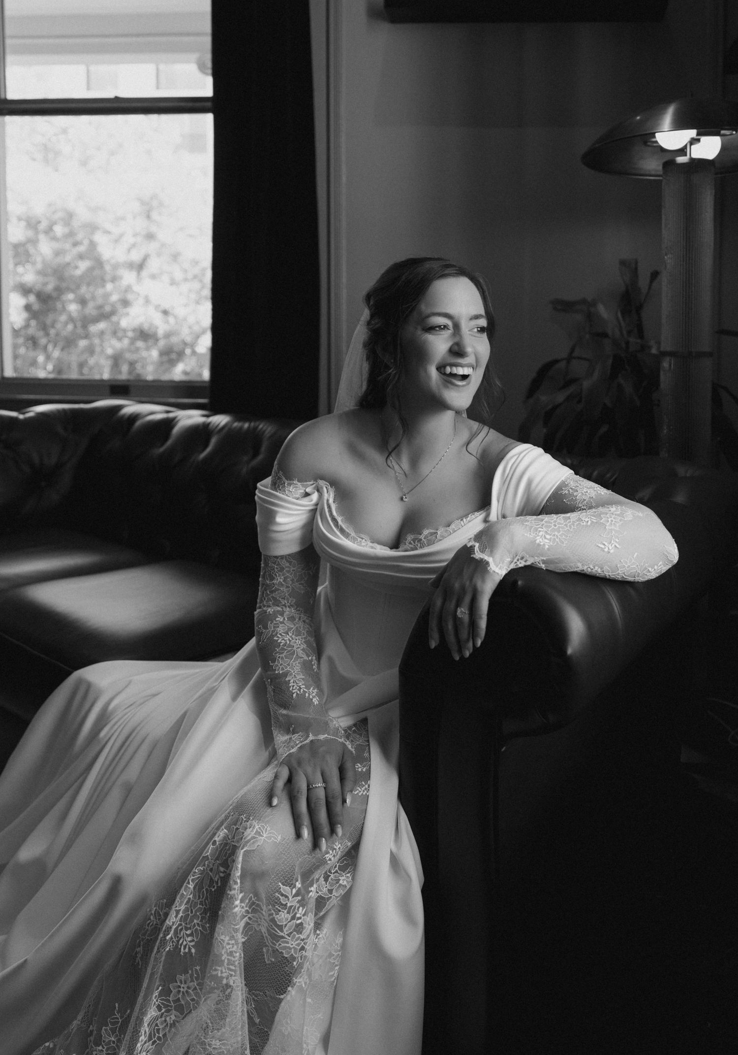 Elegant white dress photographed in dramatic black and white lighting.