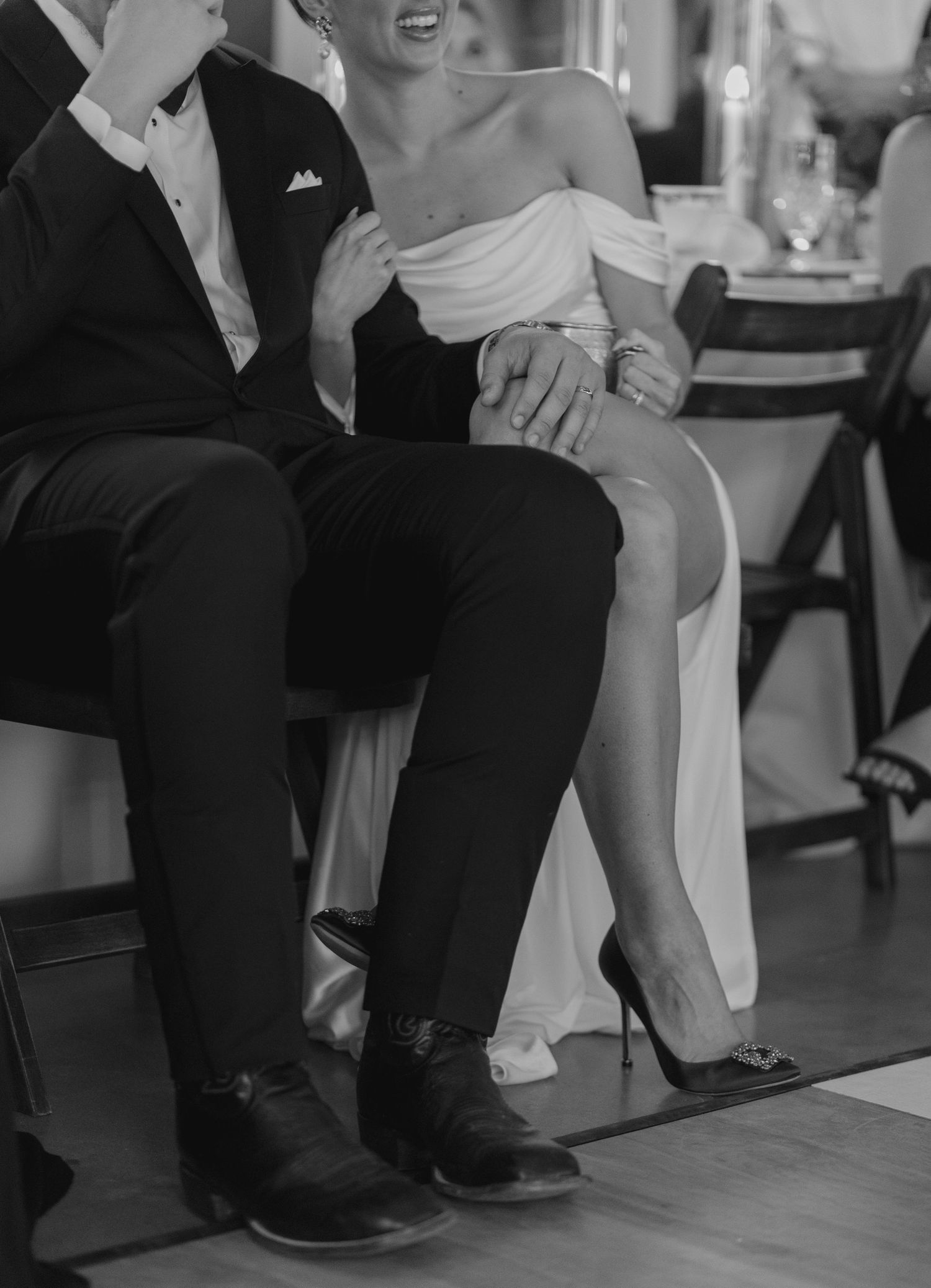 Wedding guests seated on floor in formal attire during reception.