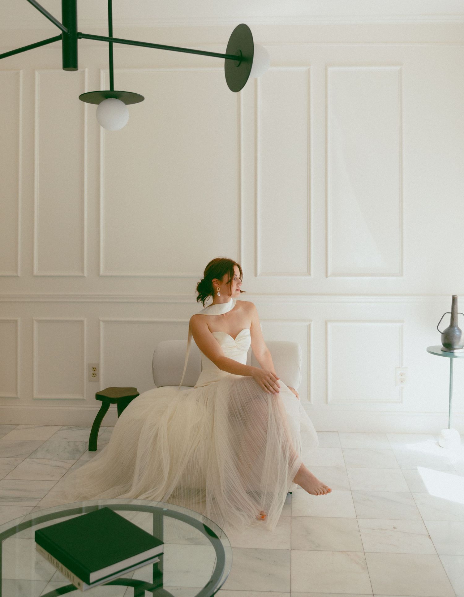 Ethereal bridal portrait in an all-white room with minimalist decor.