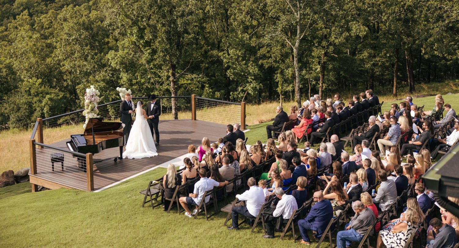Wedding guests seated outdoors with mountain views during an intimate ceremony.