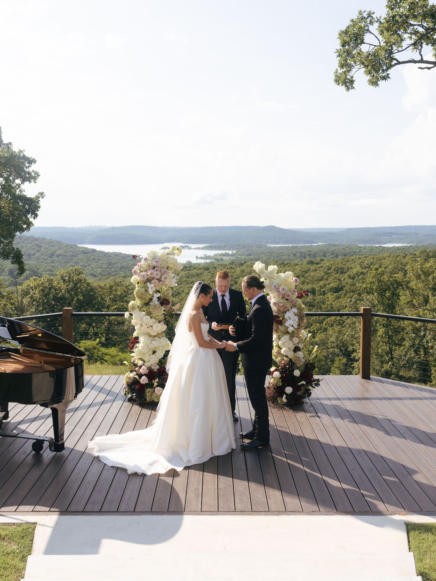 Intimate wedding ceremony taking place on an elevated deck with panoramic mountain views.