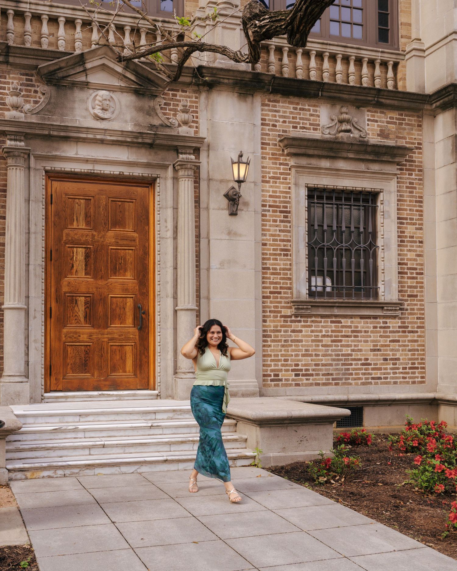 Elegant wooden door and brick facade of a historic building with stone steps and ornate architectural details.