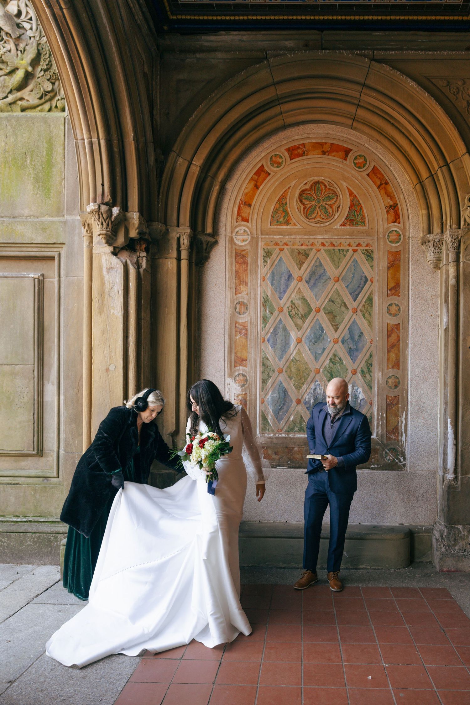A sequence of five photos showing a couple in wedding attire posing under ornate archways in a historic building.