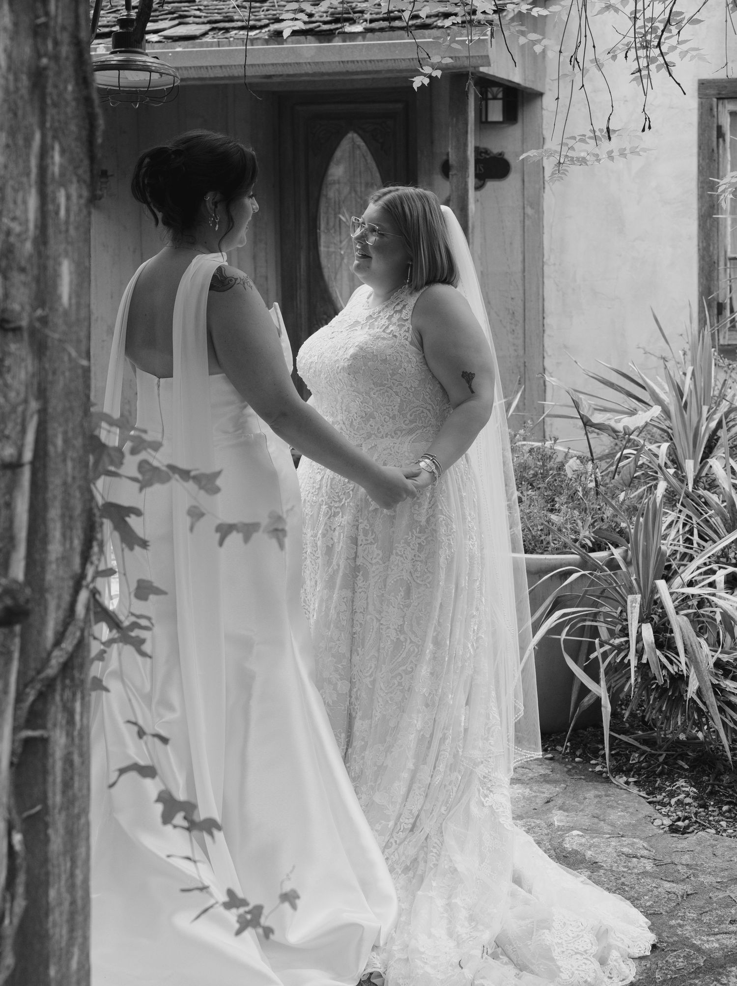 A series of black and white wedding photos showing a bride in a flowing white dress posing in an outdoor garden setting.