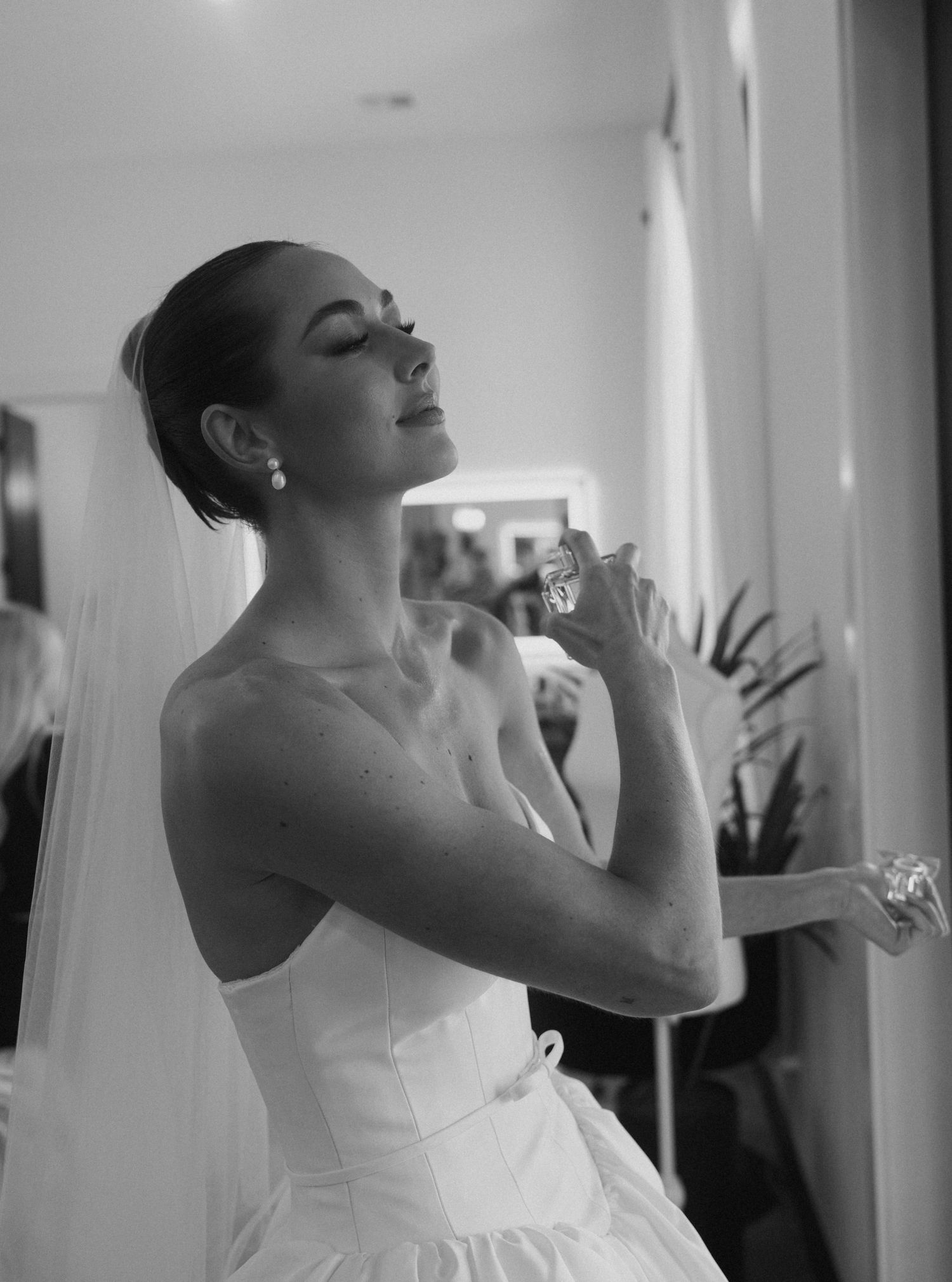A bride in a white dress preparing before the ceremony.