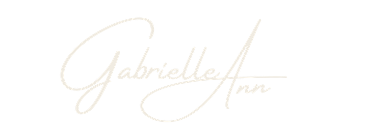 Elegant cursive signature logo of Gabriella Ann in soft cream tones on white background.