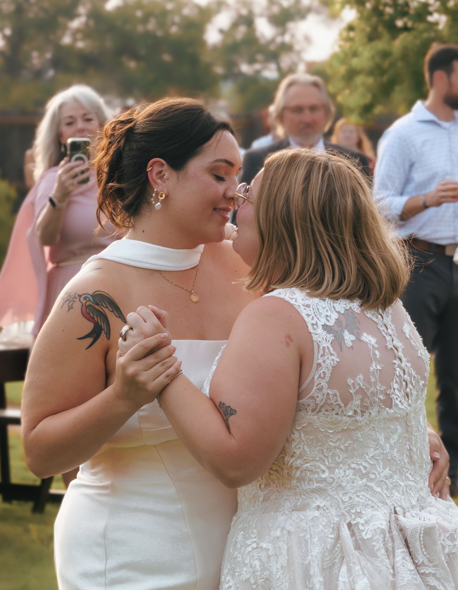 Four romantic moments captured at a wedding showing couples embracing and dancing during an outdoor celebration.