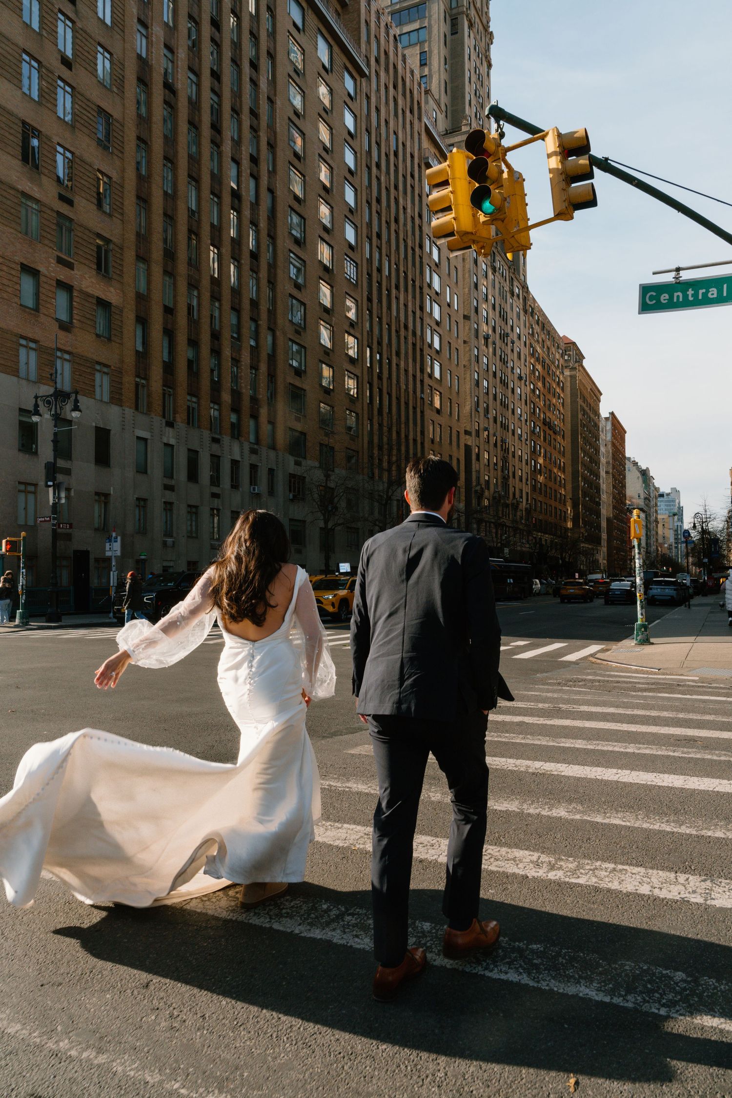 A sequence of four photos showing a bride in a white dress falling on a New York City street corner.