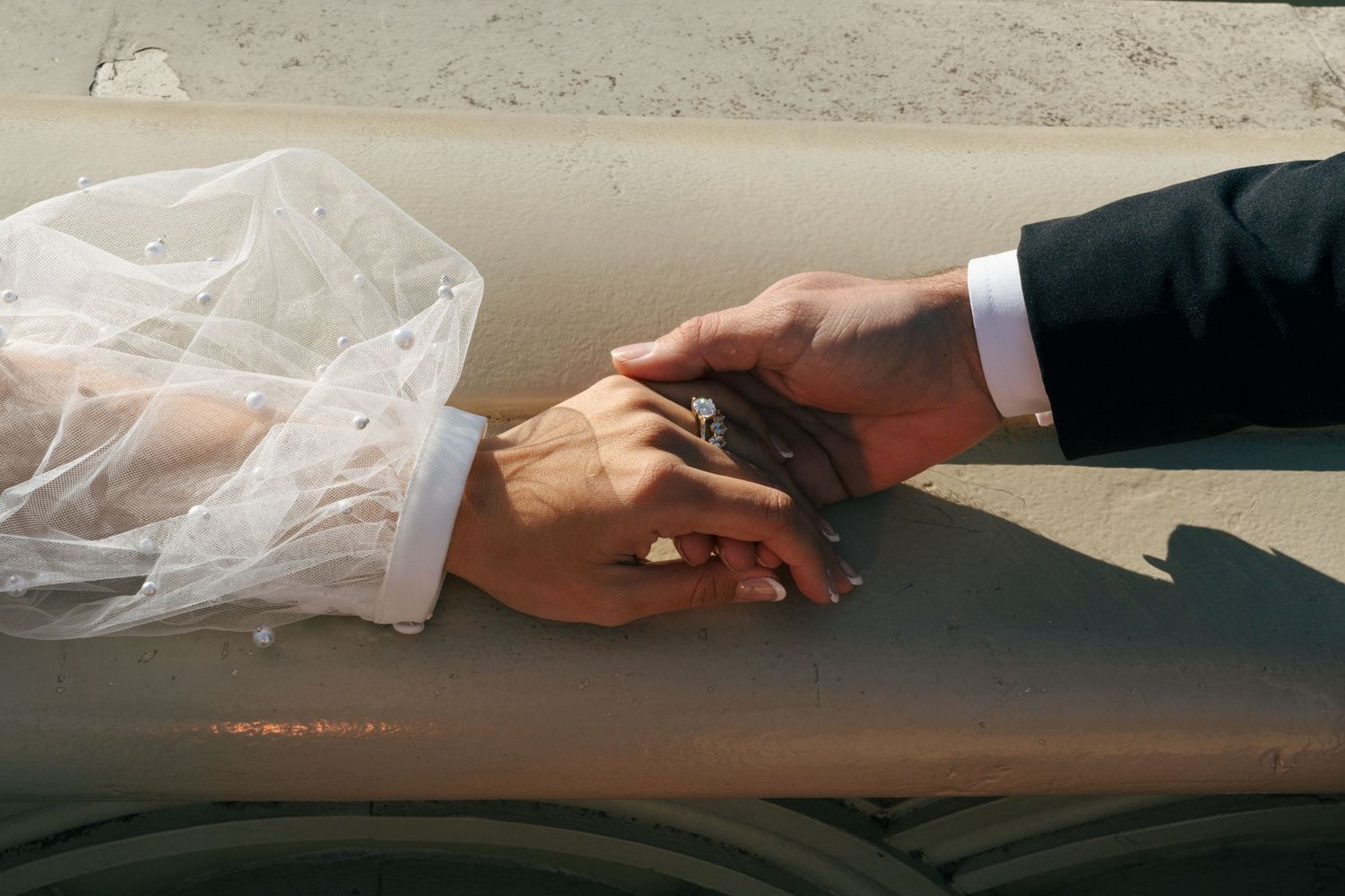 A sequence of hands placing a small object into a plastic bag in multiple steps shown from left to right.
