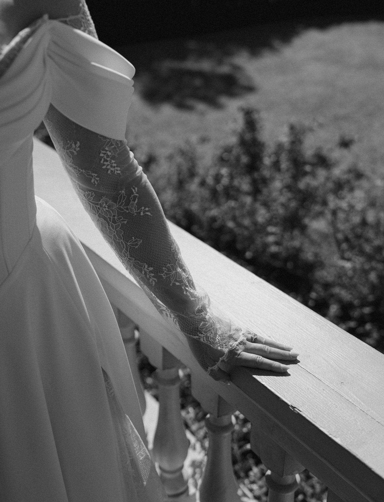 Close-up detail of white lace against a dark background in dramatic lighting.
