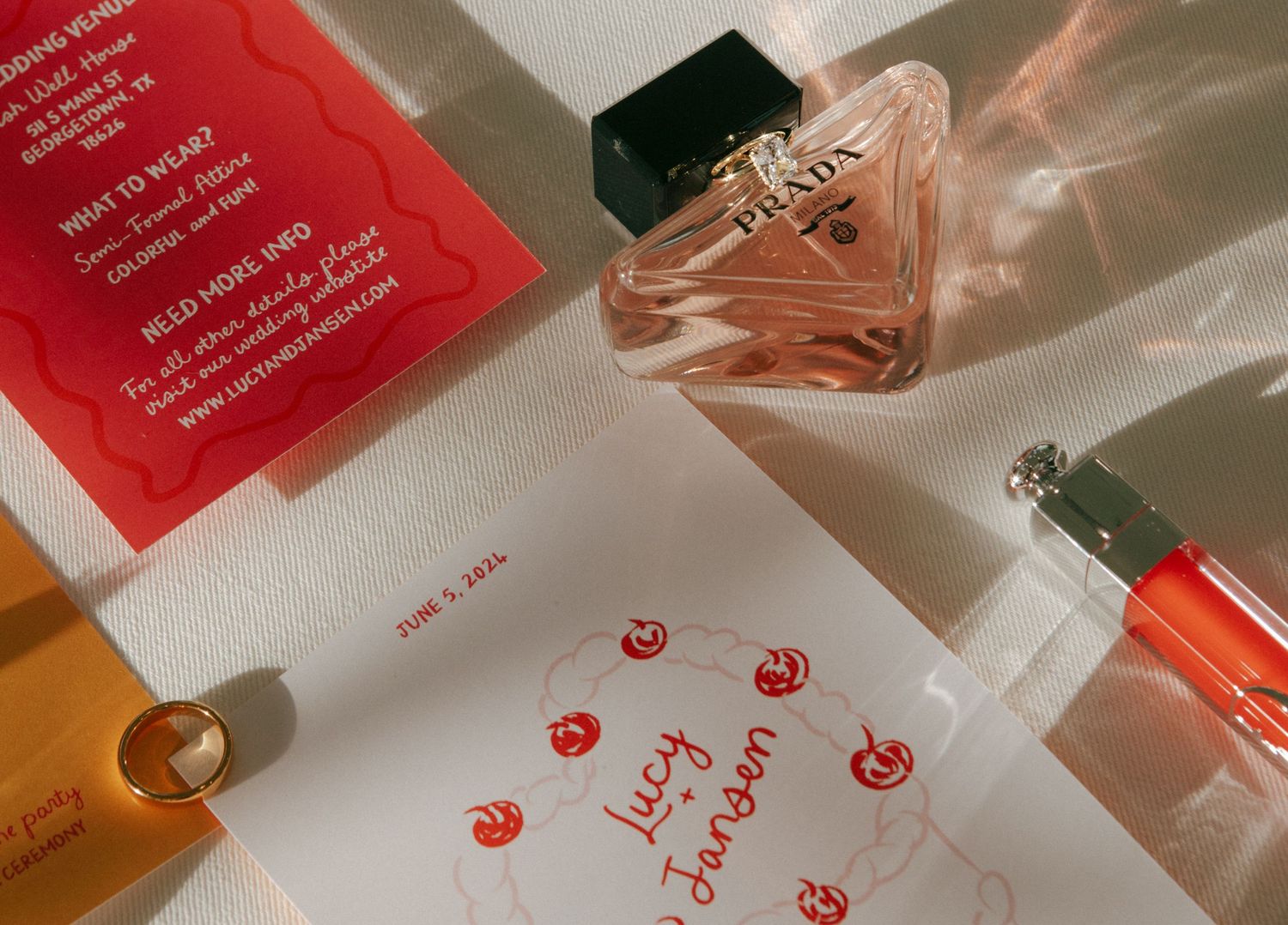 Red and peach colored wedding invitation cards with decorative details.