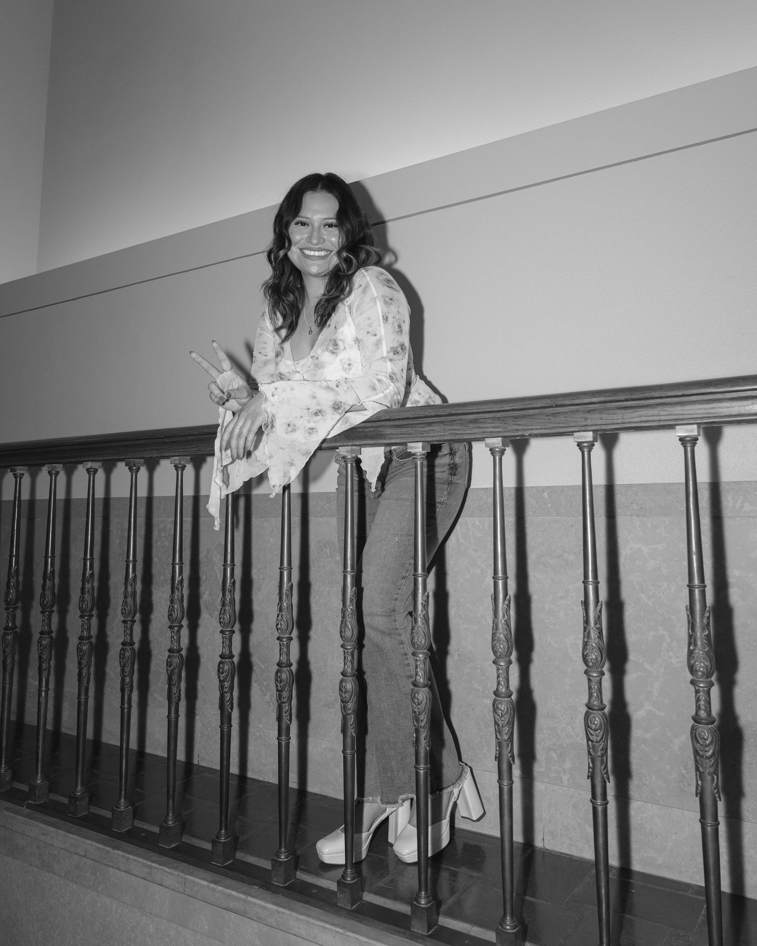 A black and white photo sequence showing a person playfully peeking and hiding behind a wall in multiple frames.