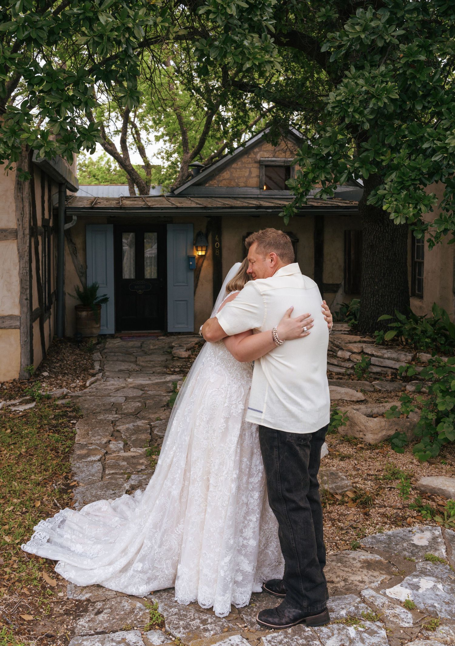 A romantic moment captured in a series of four photos showing a couple embracing outdoors near a rustic building.