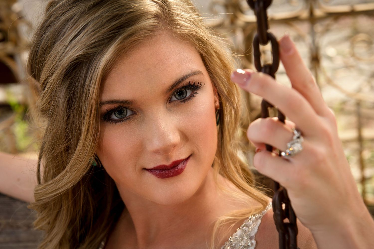Close-up shot of elegant bridal makeup and jewelry details.