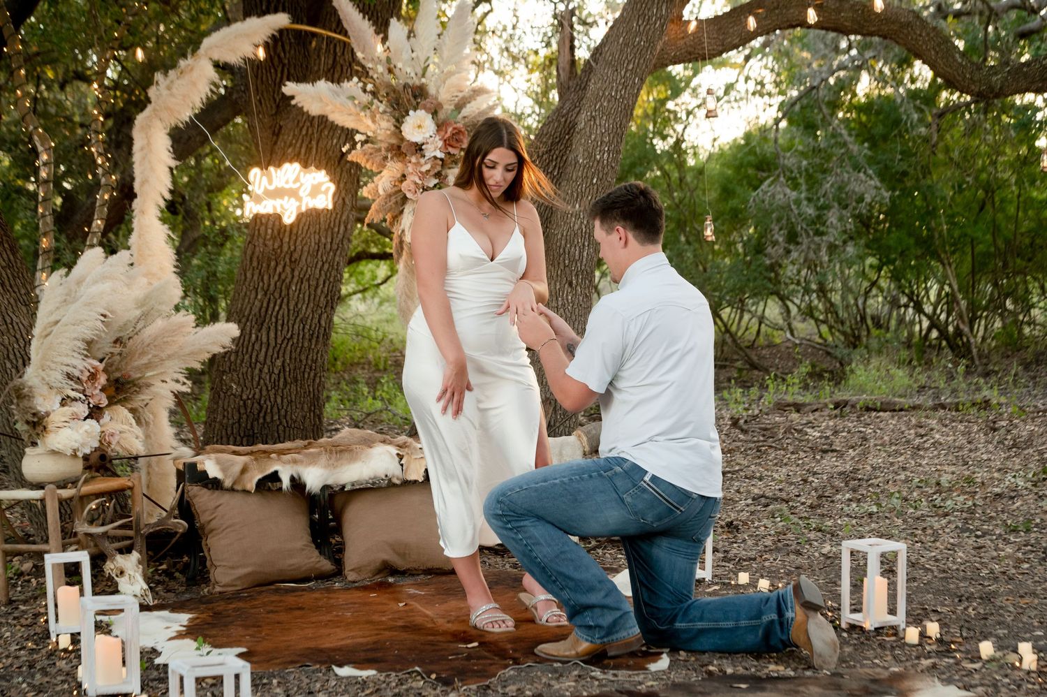 Intimate outdoor scene with couple seated among lanterns and bohemian decorations.