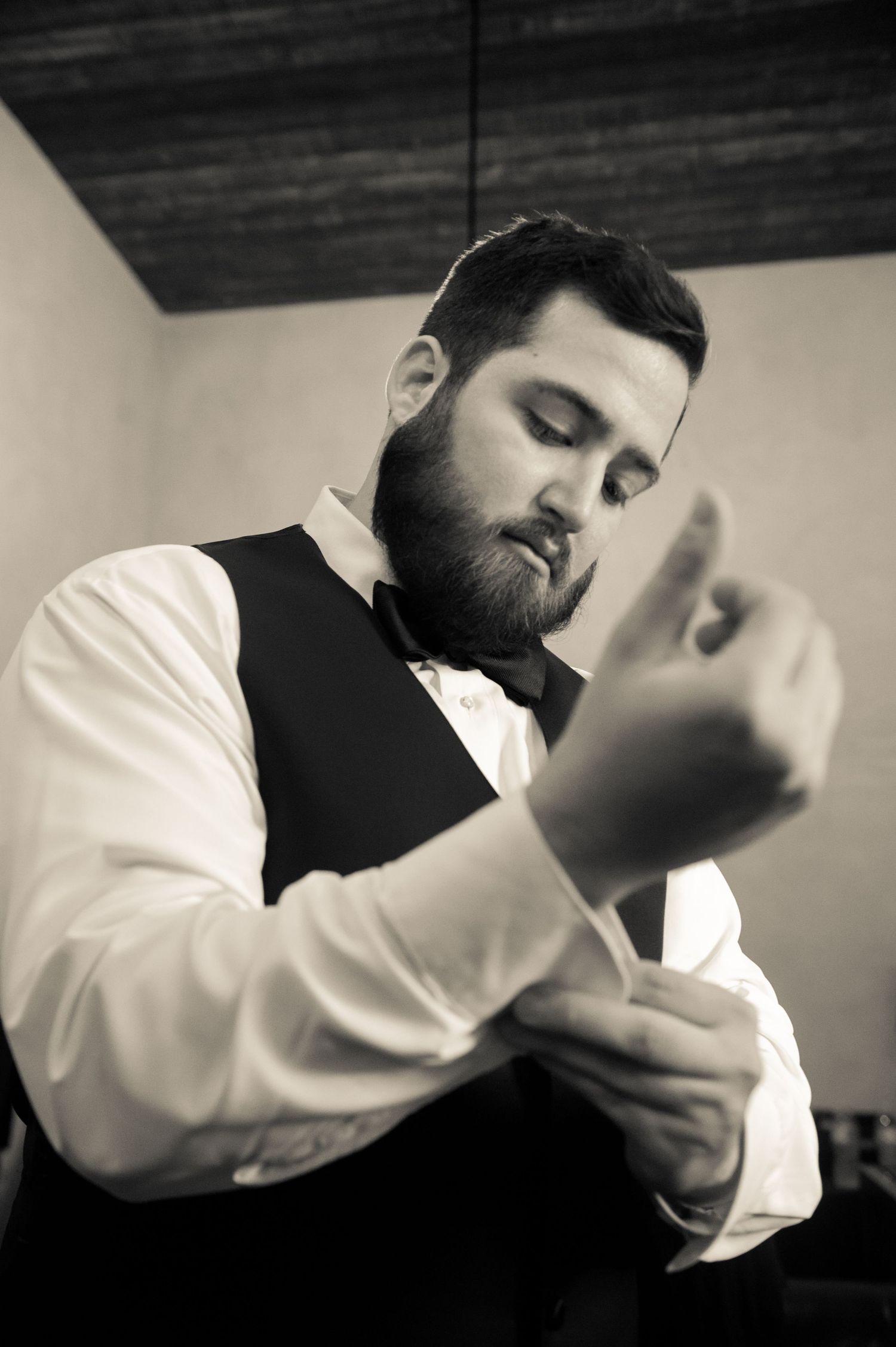 Artistic black and white series of groom preparation moments.
