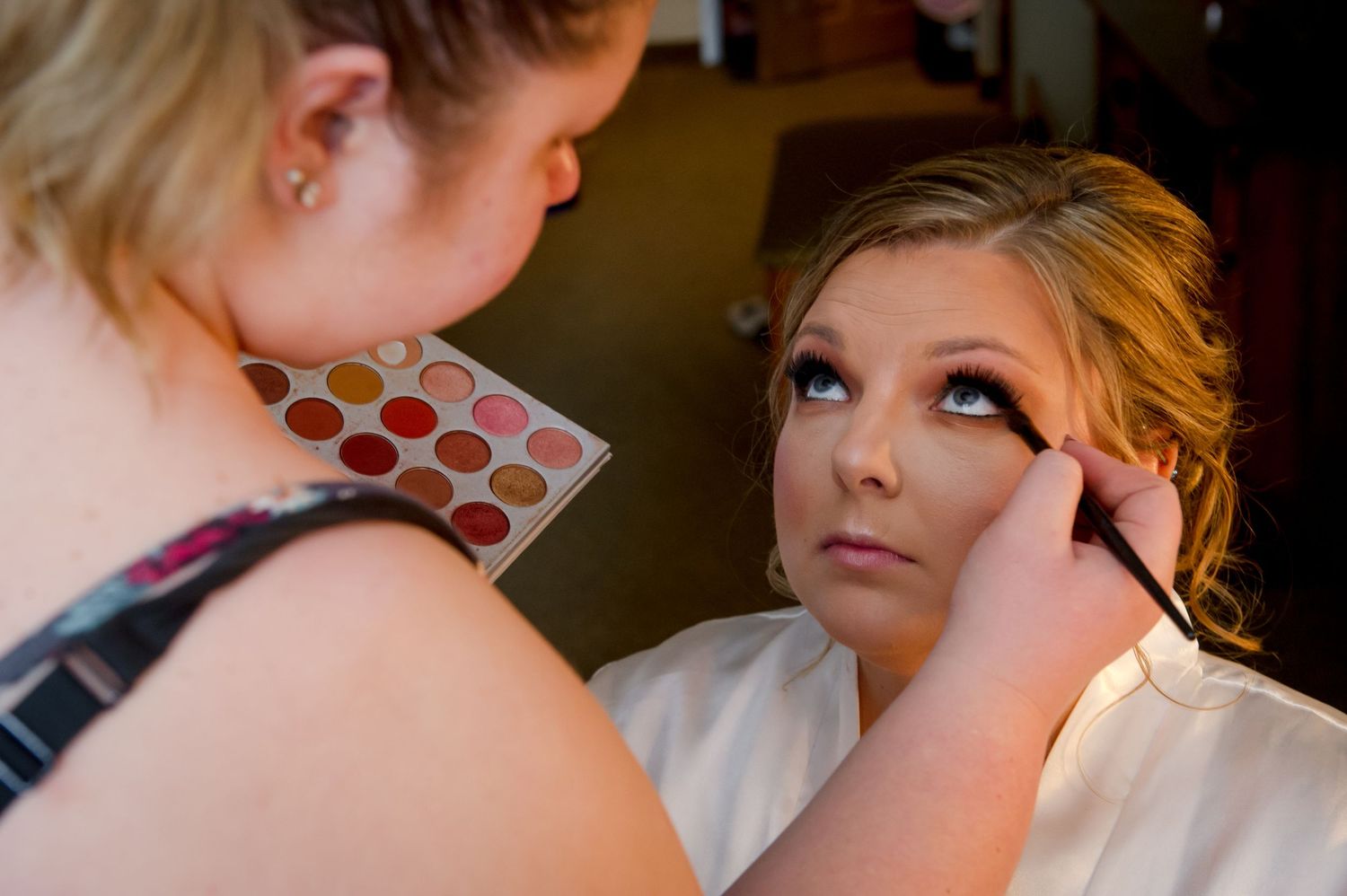 Close up shots of makeup application and hair styling preparations for a wedding day.
