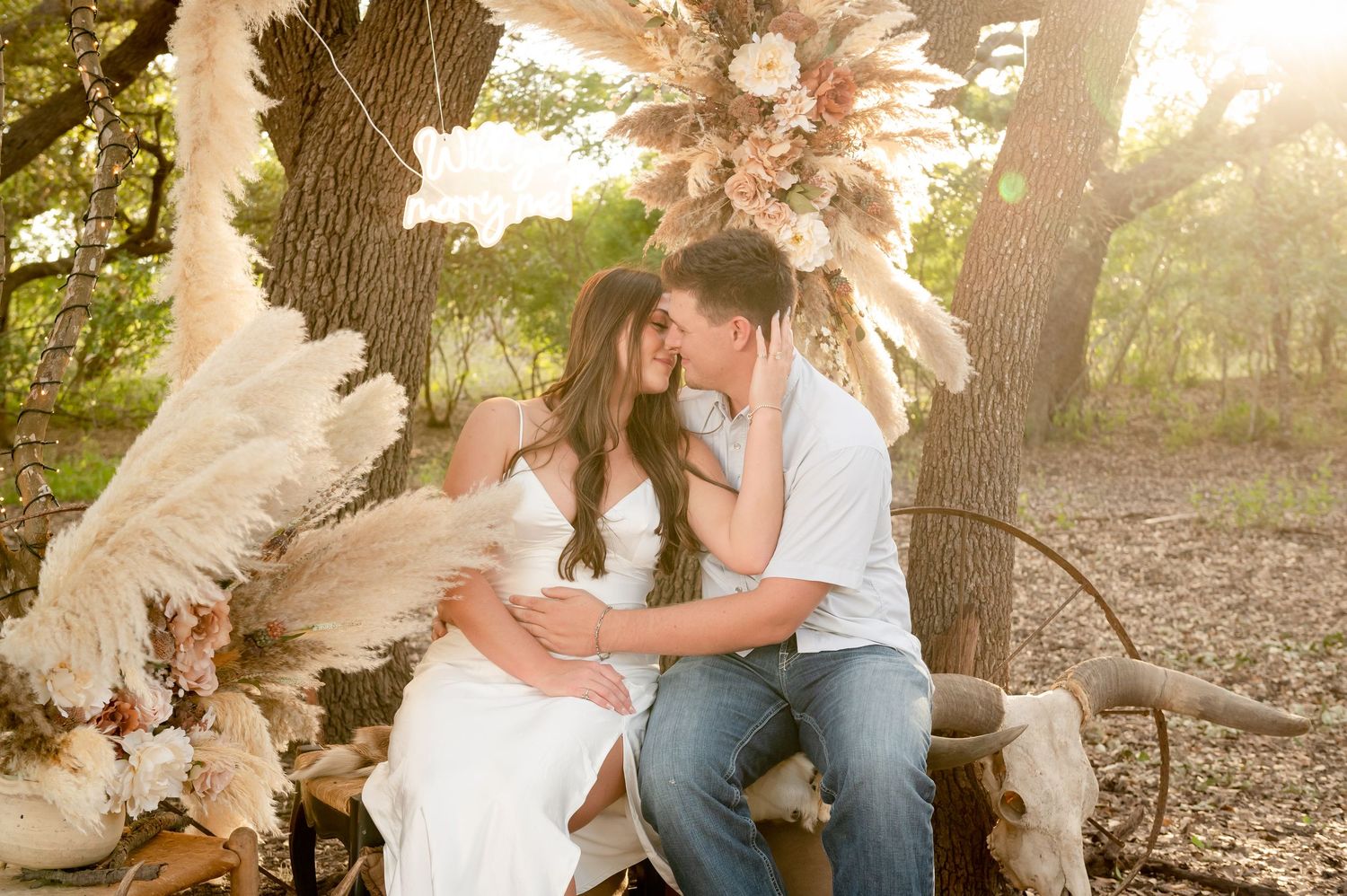 Intimate moment shared under a bohemian arch decorated with pampas grass and dried flowers.