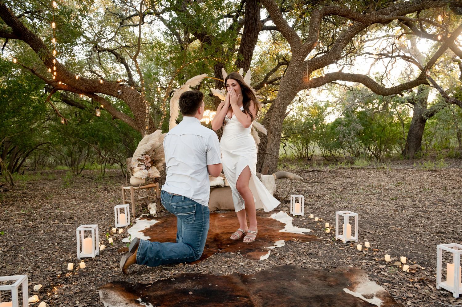 Couple shares special moment in decorated outdoor setting with lanterns and paper flowers.