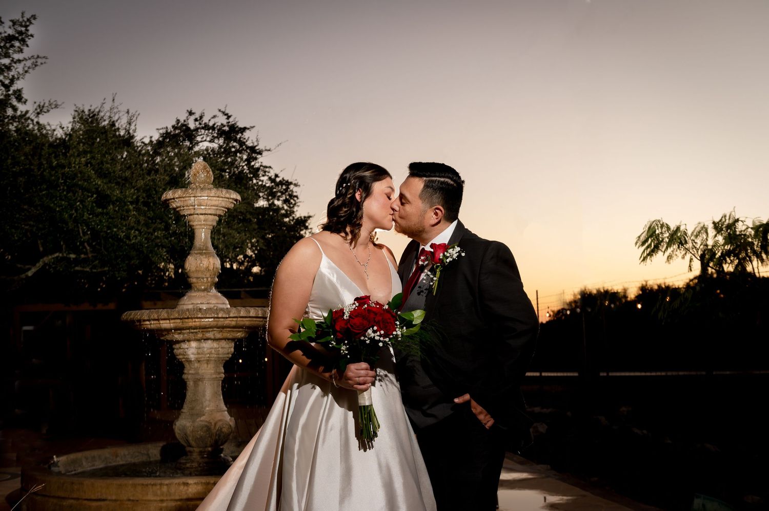 A romantic sunset wedding portrait with warm golden light.