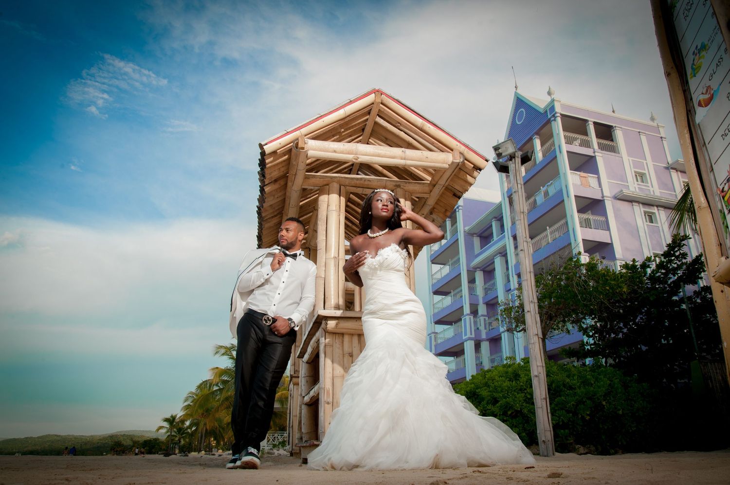 Wedding photography at a coastal venue with pastel colored buildings in background.